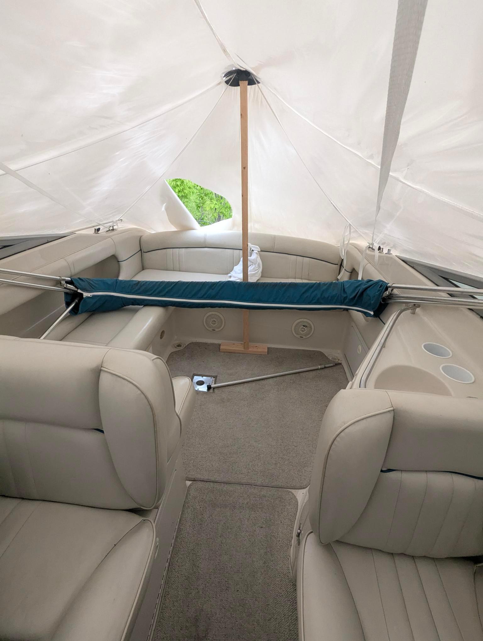 1999 Crownline 266 CCR boat interior with beige seating and canopy cover.