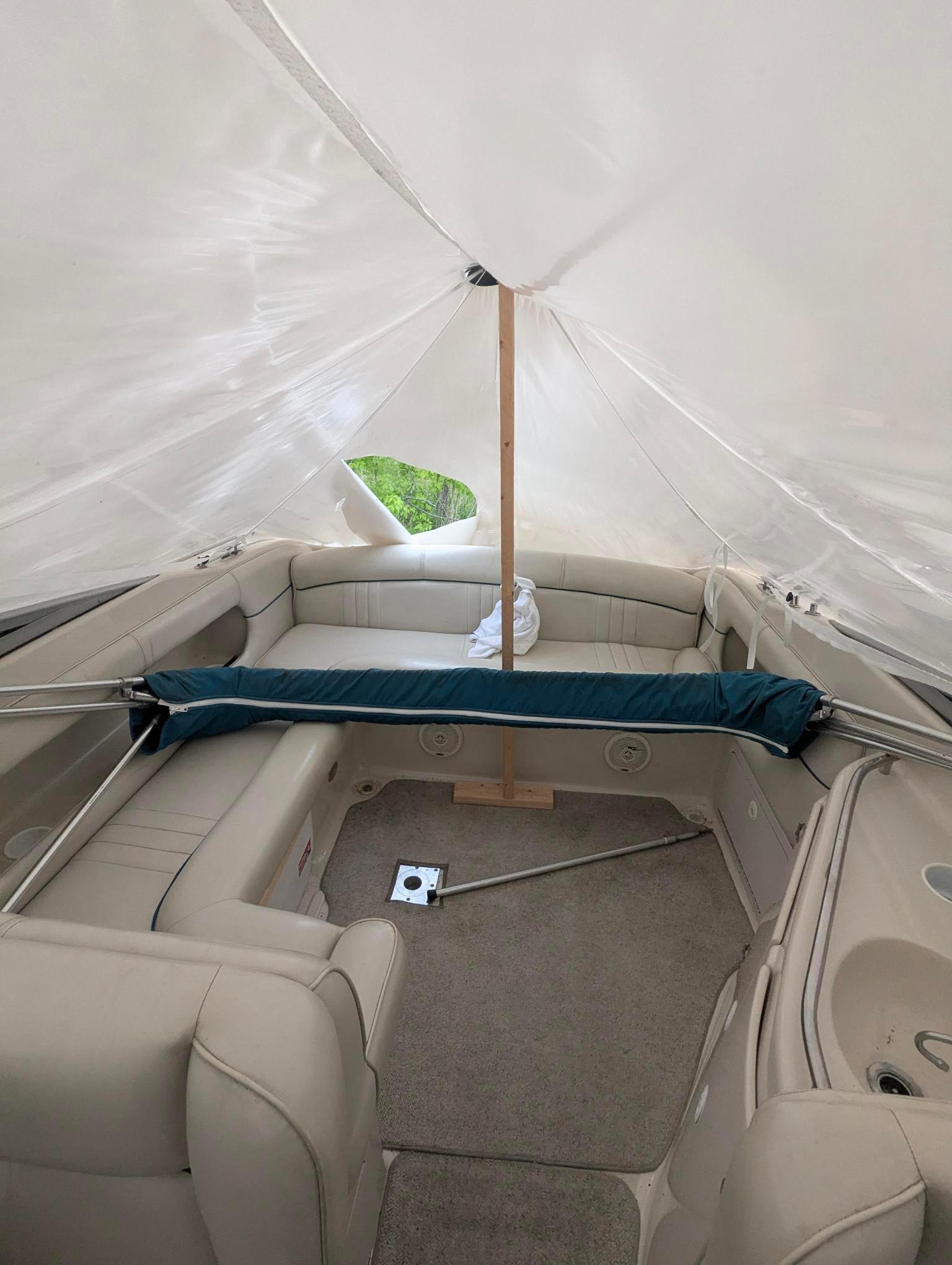 1999 Crownline 266 CCR boat interior with beige seating and canopy cover.