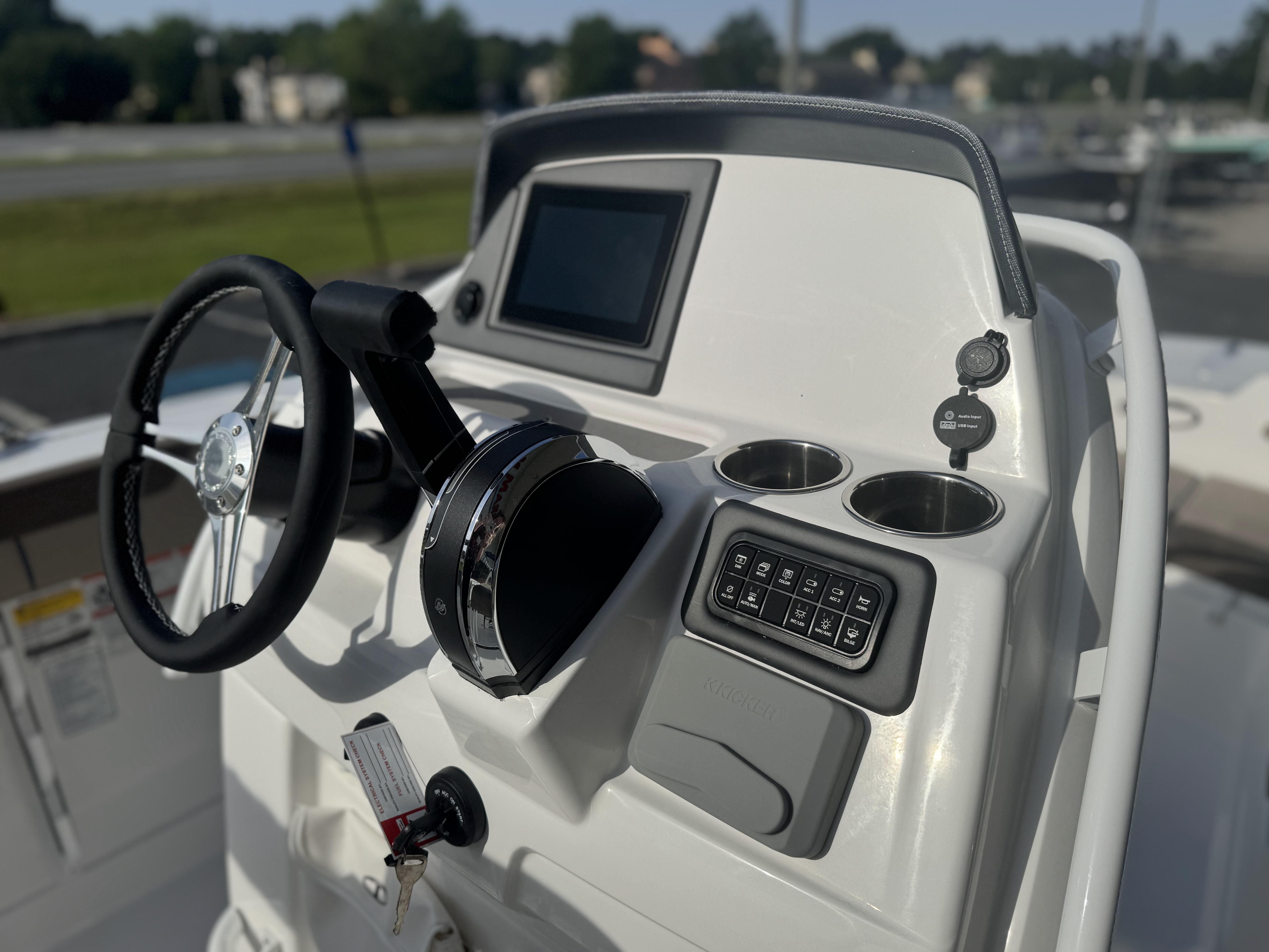2025 Tahoe 2150 CC boat dashboard with steering wheel and control panel.