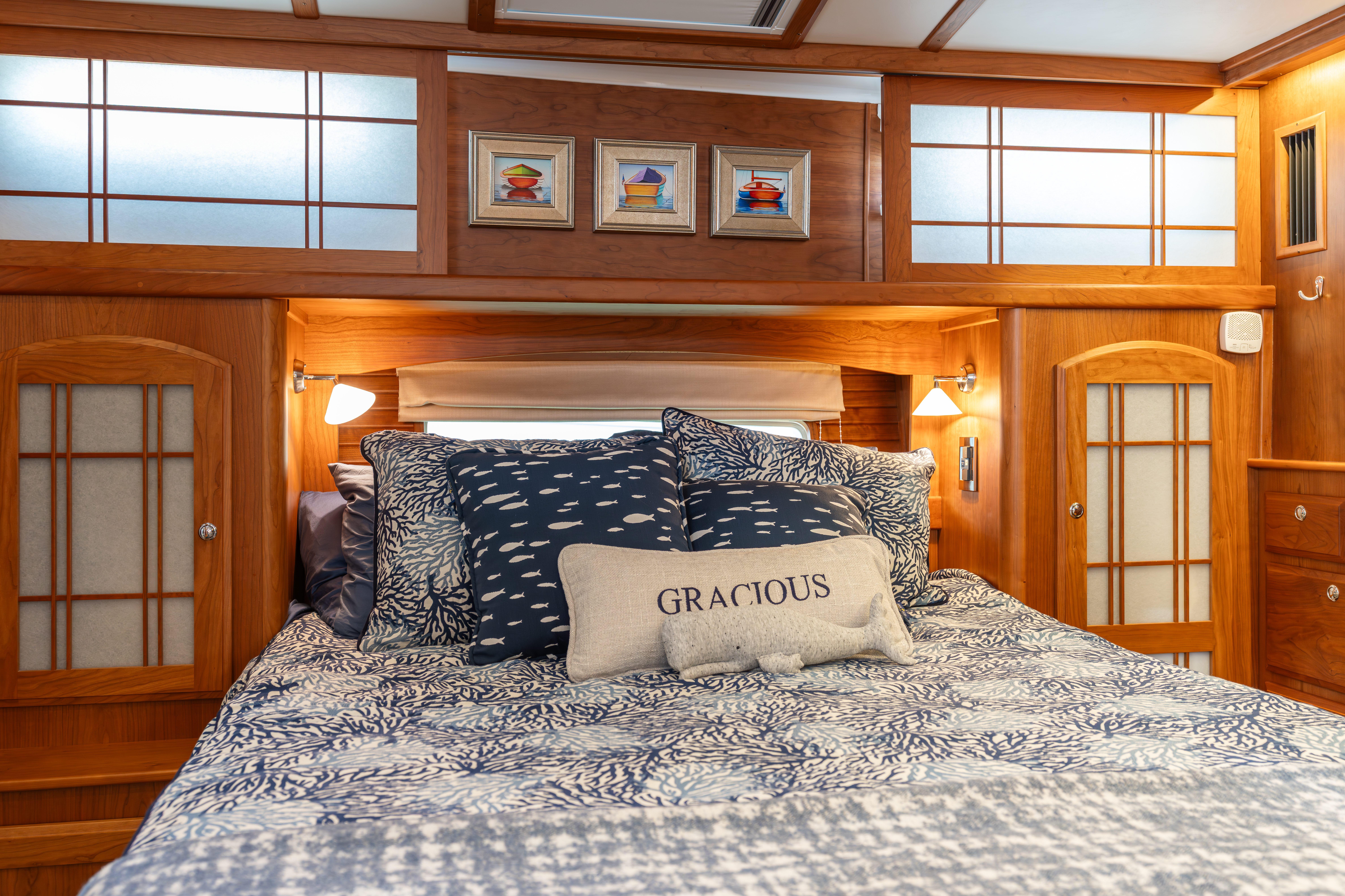 Luxurious bedroom interior of 2020 Sabre 48 Salon Express yacht with elegant wood accents.