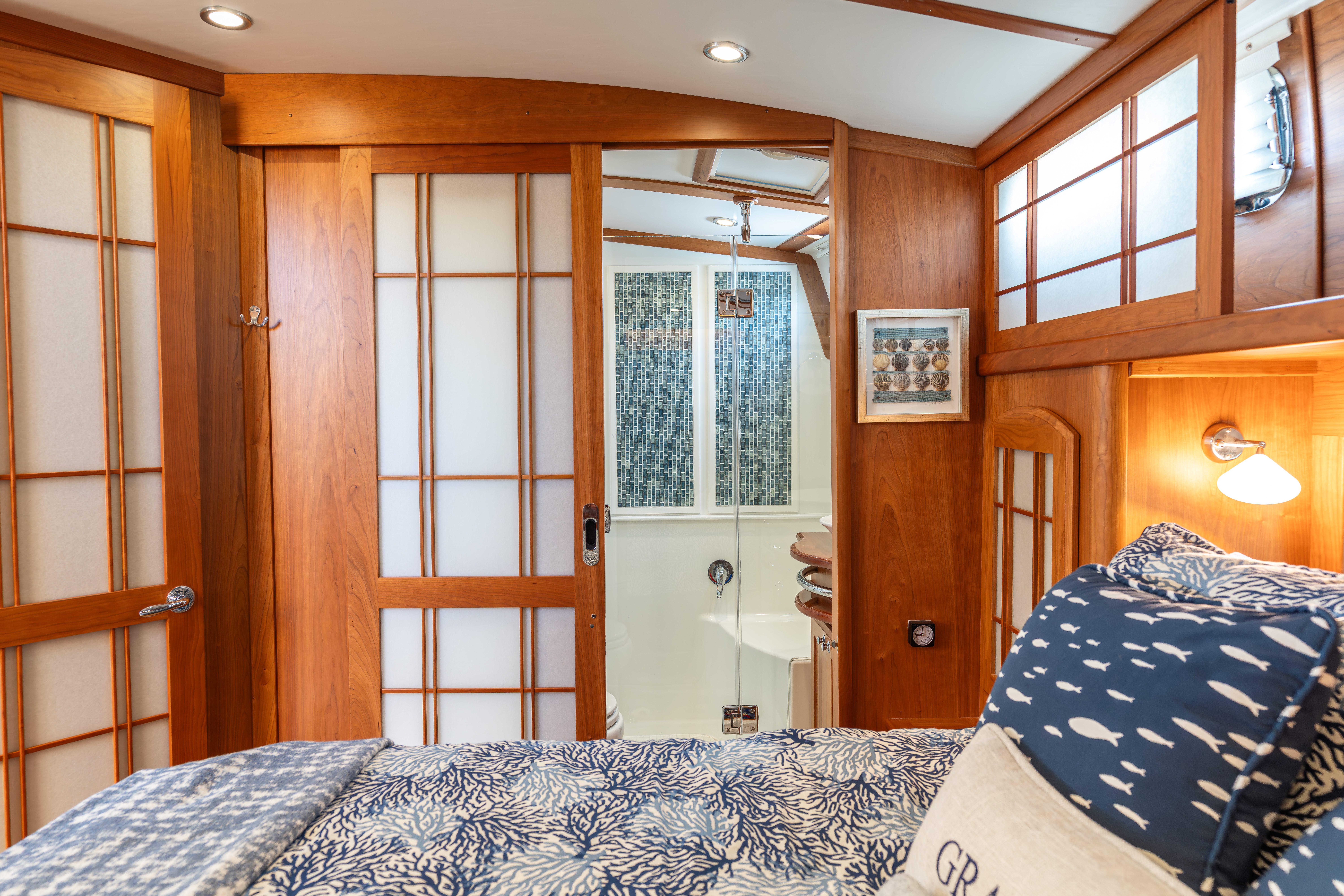 Interior of 2020 Sabre 48 Salon Express with wooden accents and cozy bedding.