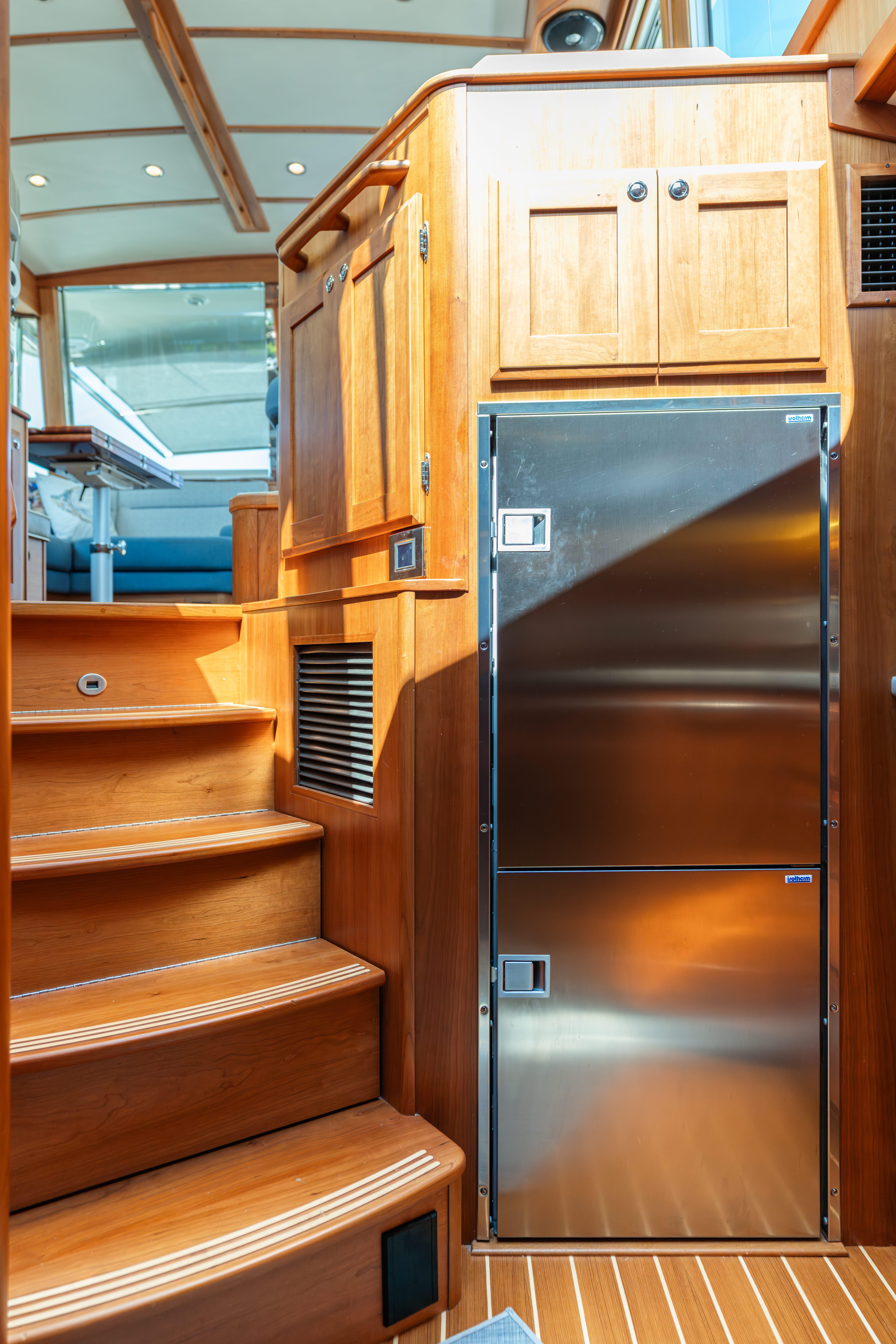 Interior of 2020 Sabre 48 Salon Express with wooden cabinetry and stainless steel appliances.