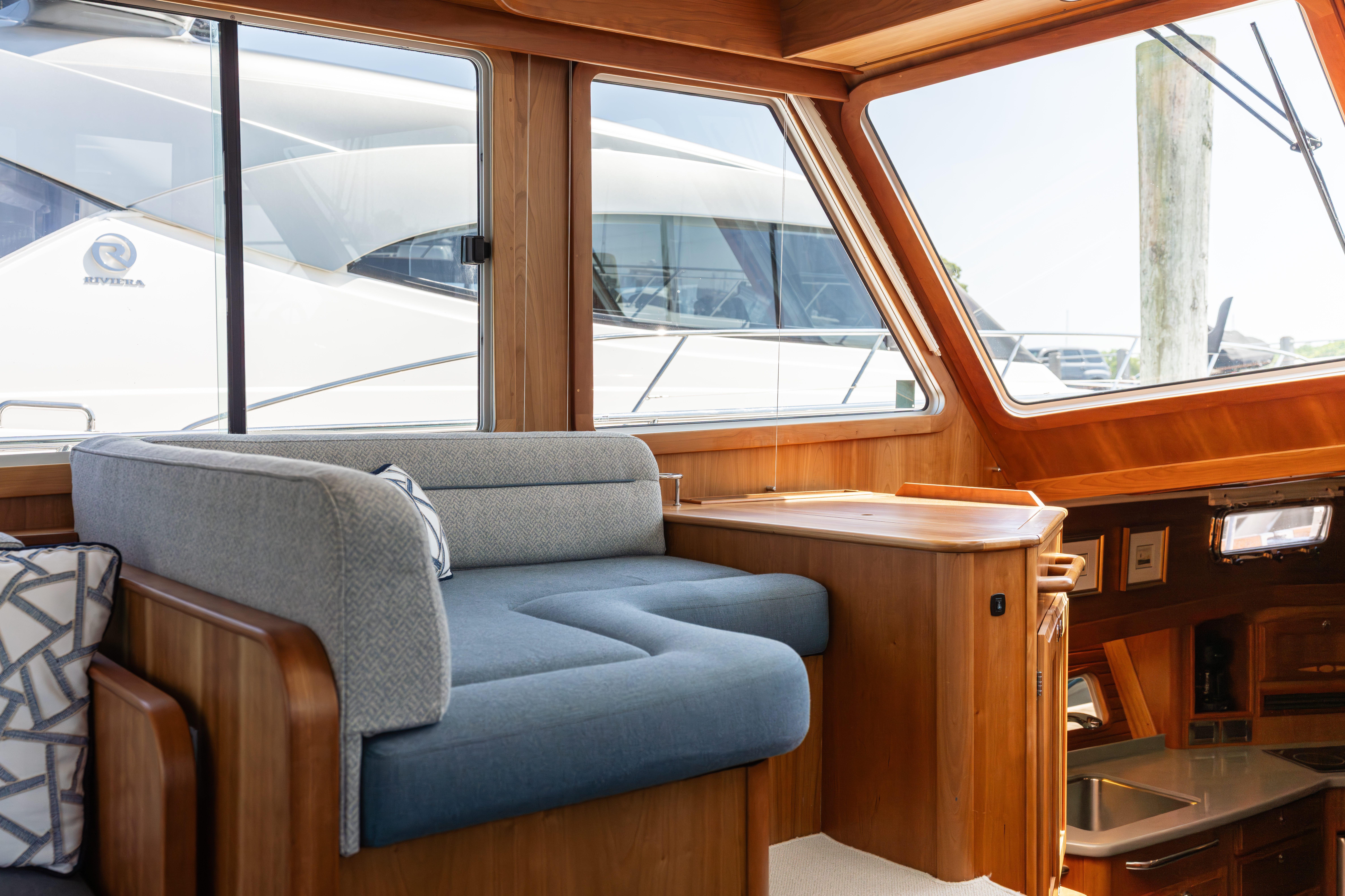 Interior of 2020 Sabre 48 Salon Express yacht with wooden finish and blue seating.