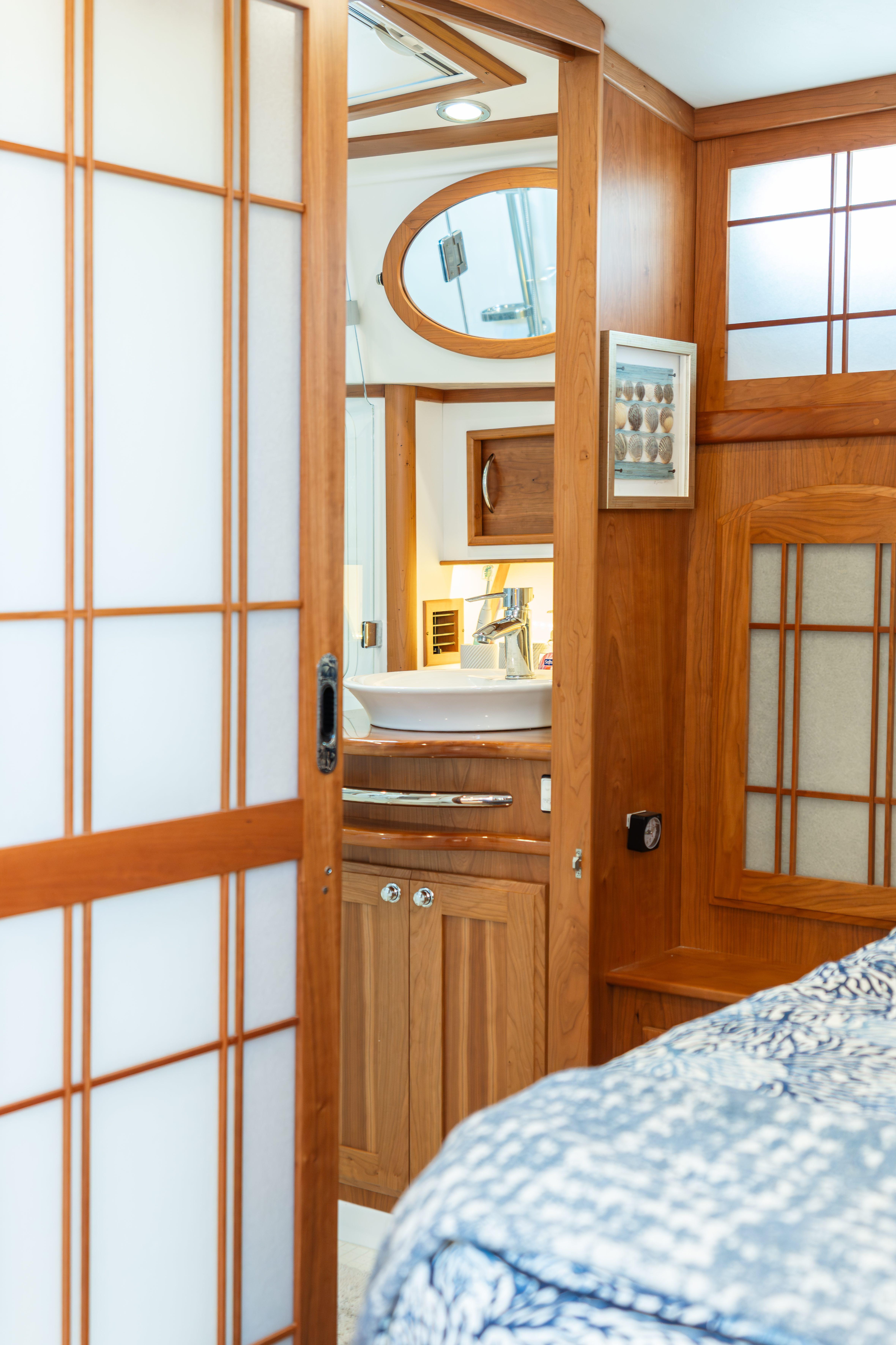 Interior of 2020 Sabre 48 Salon Express yacht with wooden accents and modern bathroom.