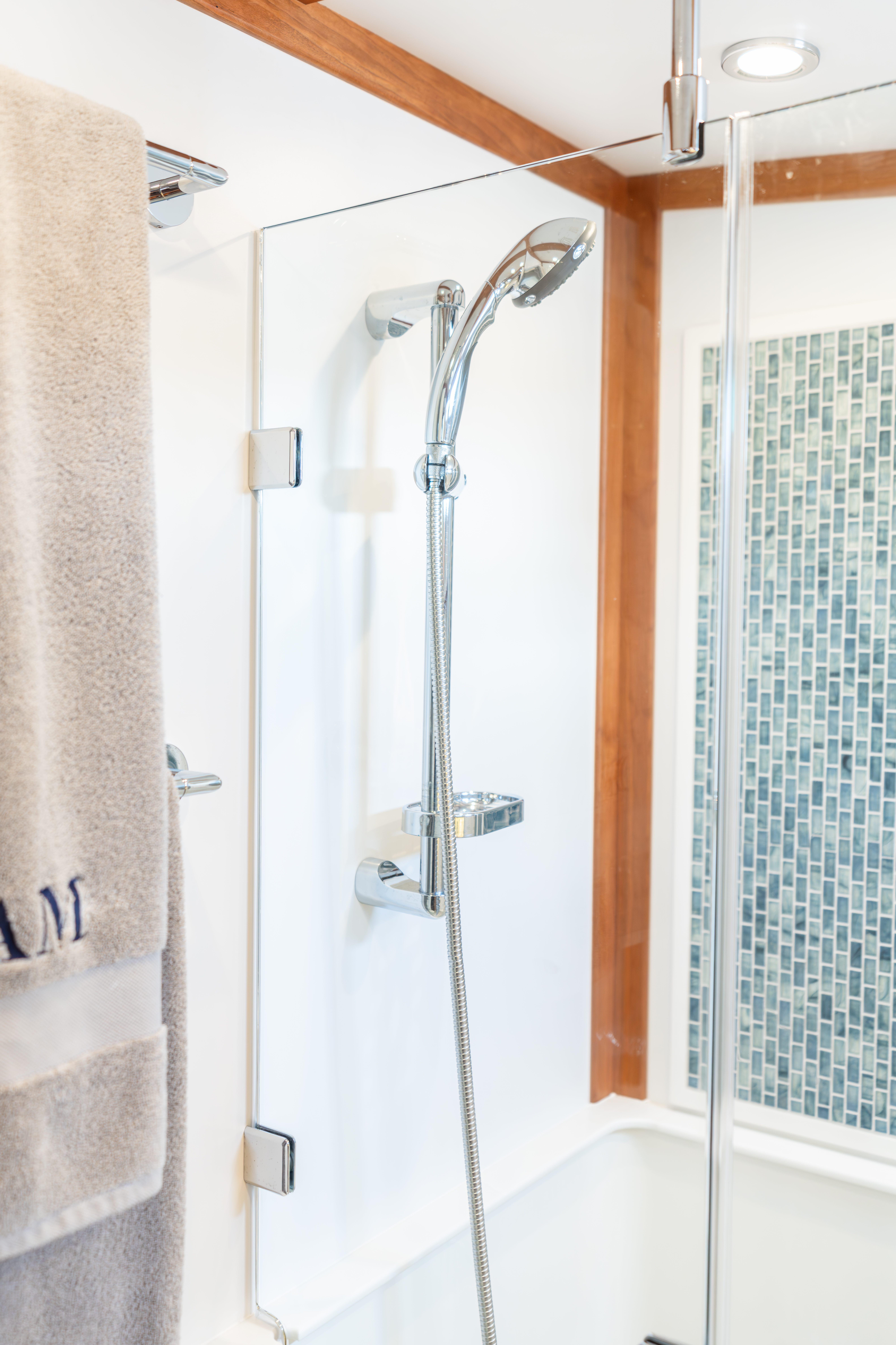 Shower area in 2020 Sabre 48 Salon Express yacht with modern fixtures and glass door.