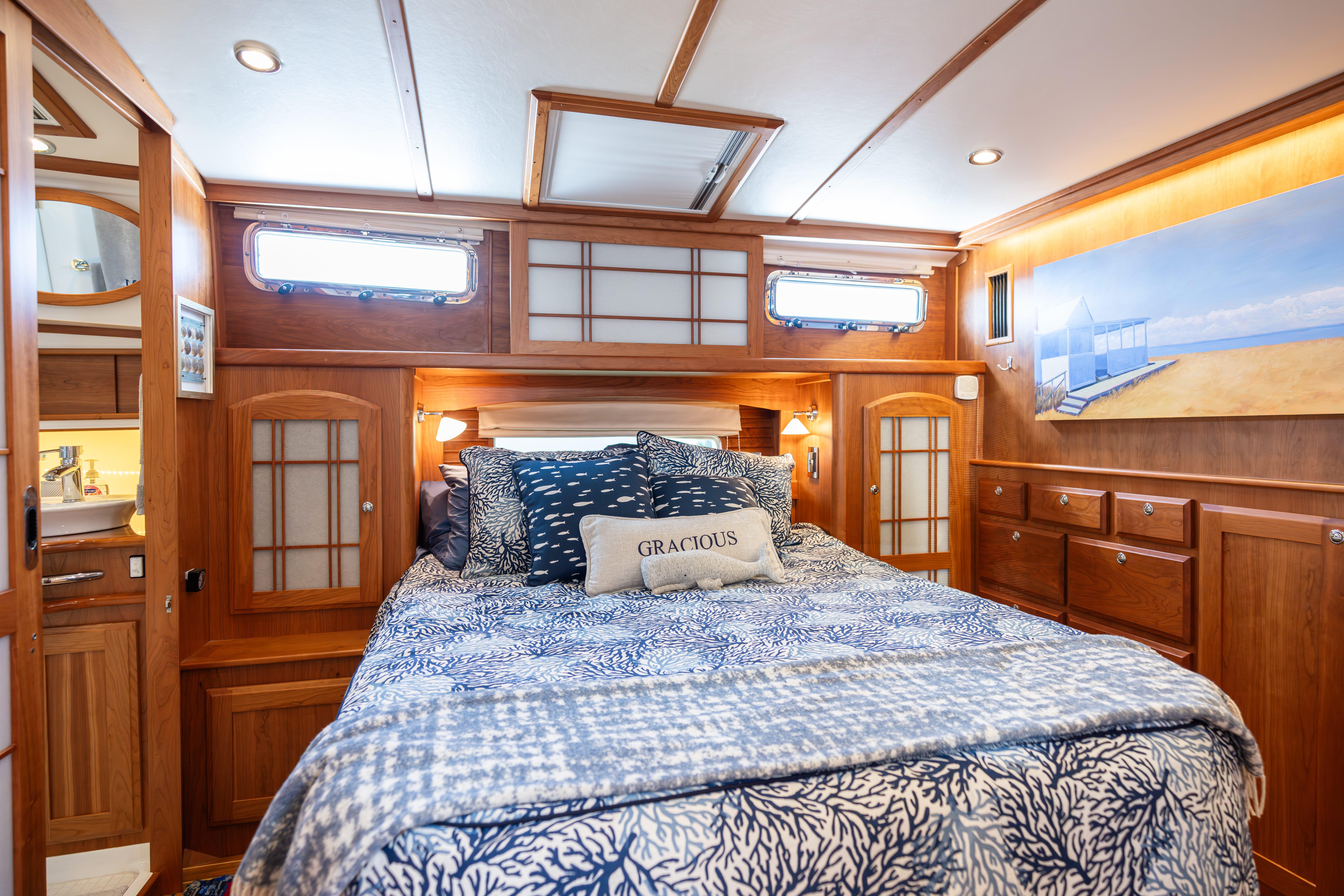 Luxurious bedroom interior of 2020 Sabre 48 Salon Express yacht with elegant wood finishes.