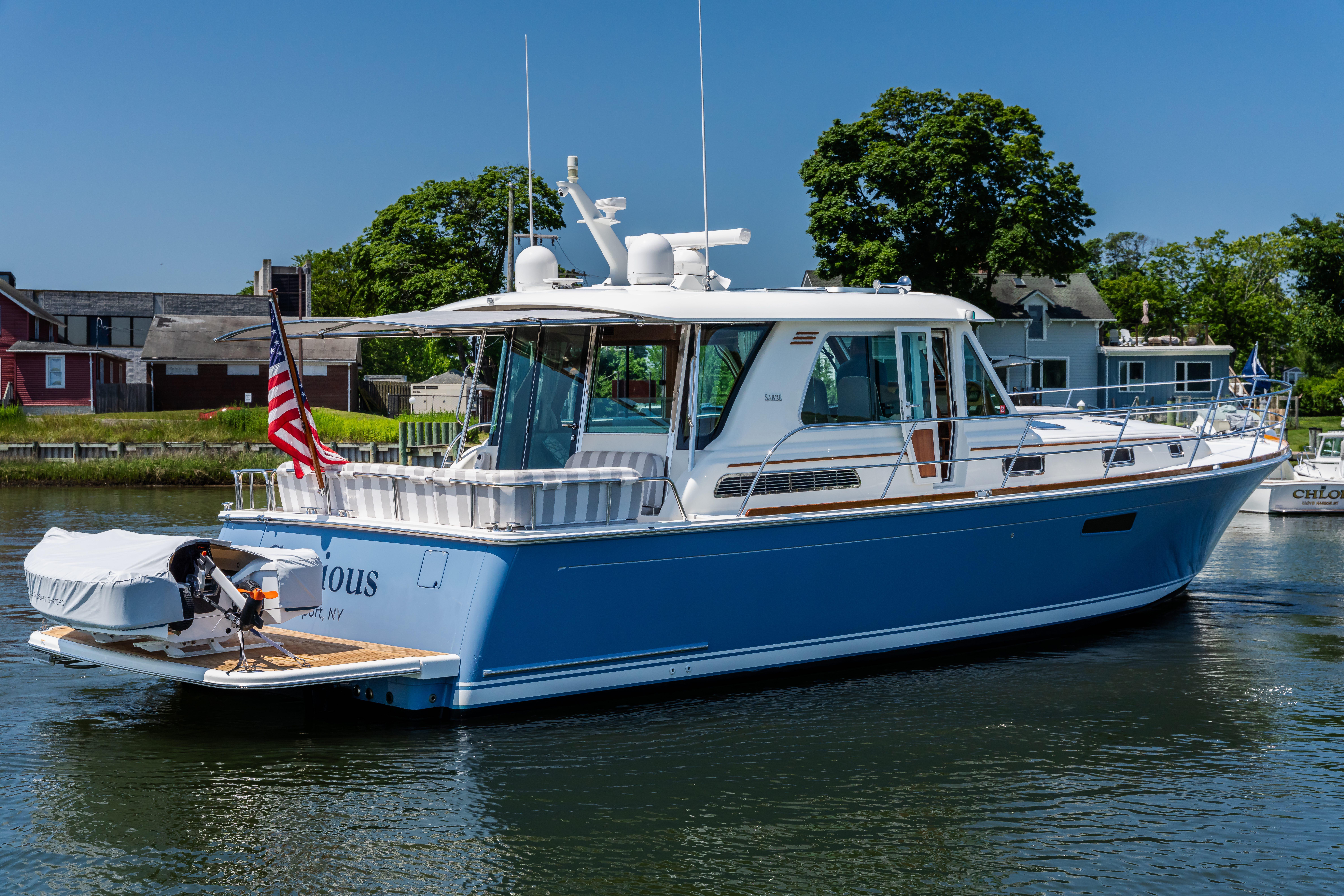 2020 Sabre 48 Salon Express yacht on water, featuring sleek design and American flag.
