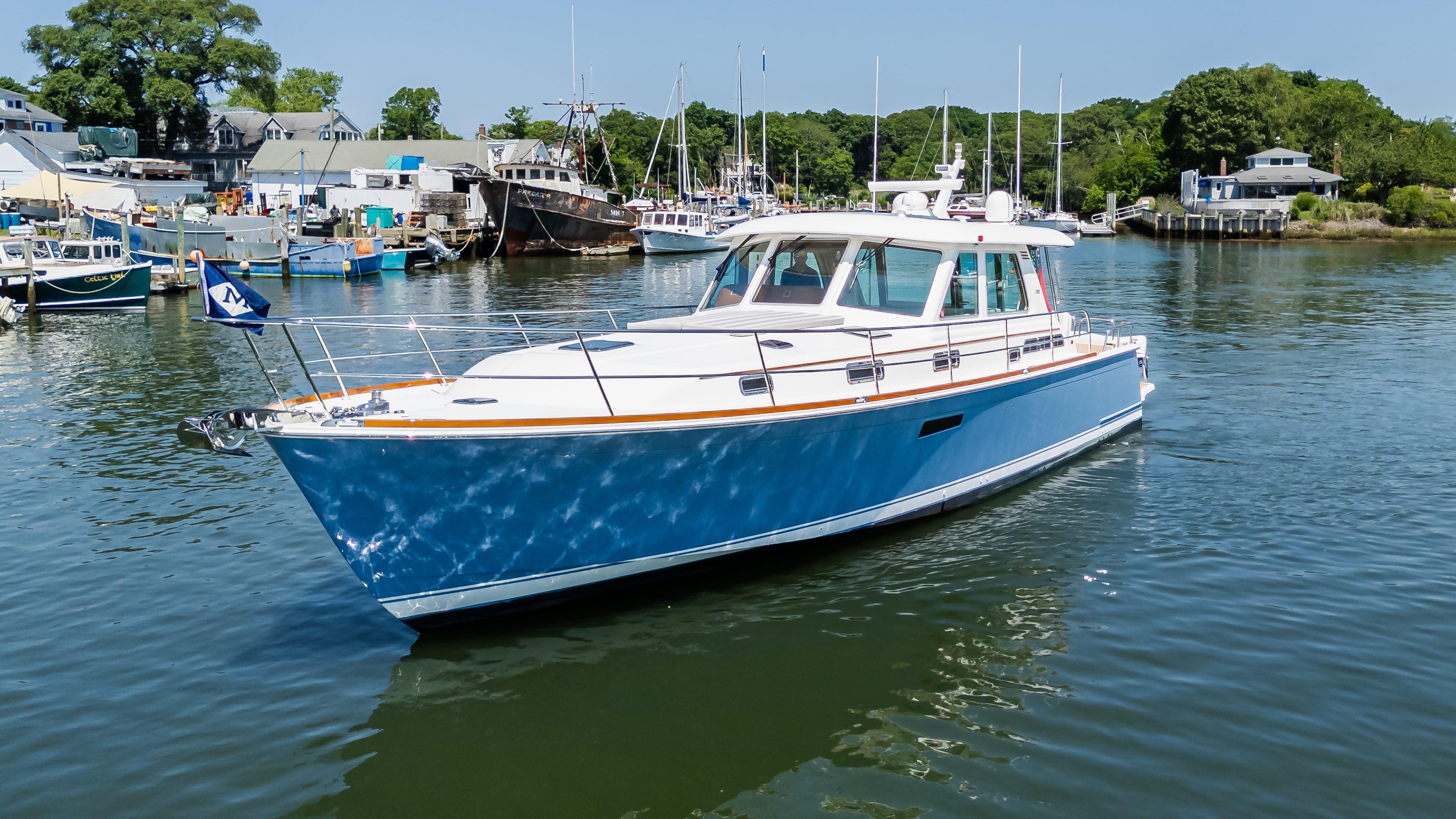 2020 Sabre 48 Salon Express yacht docked in a scenic marina.