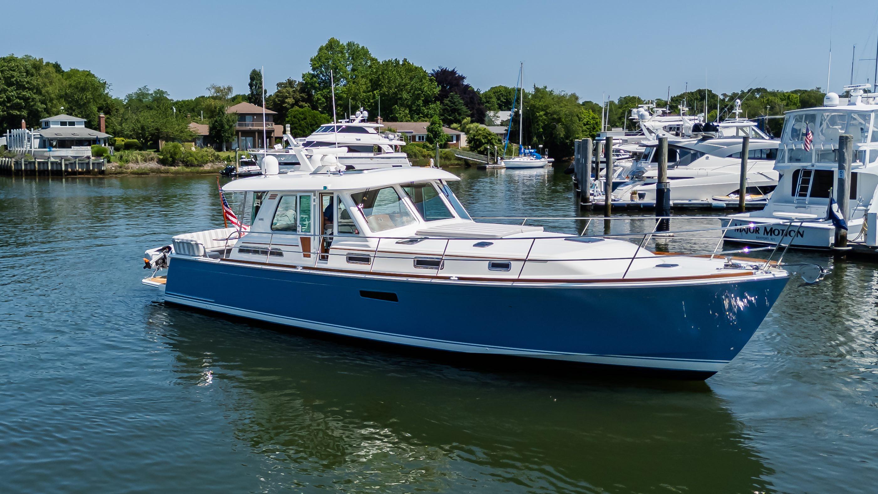 2020 Sabre 48 Salon Express yacht docked in a serene marina setting.
