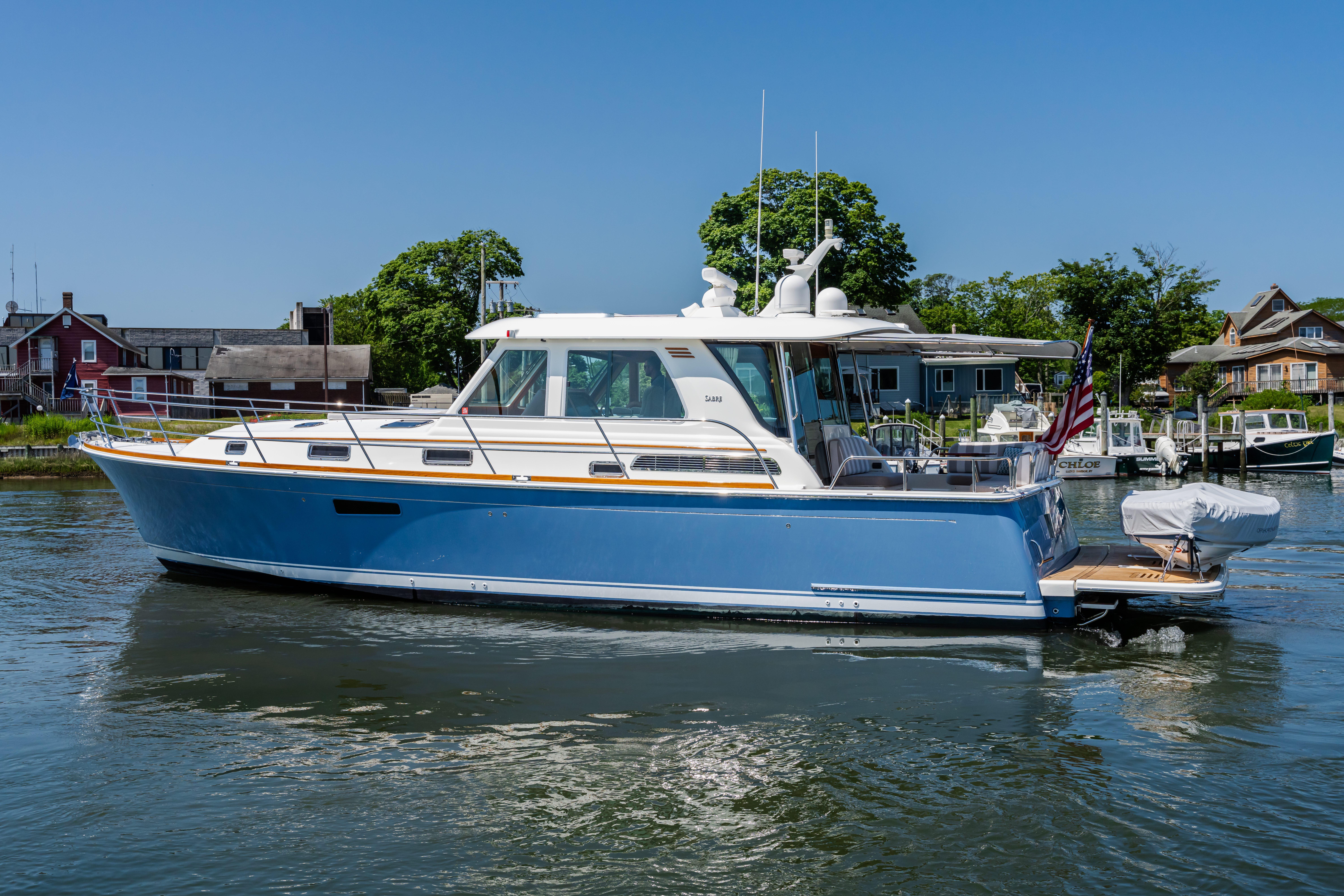 2020 Sabre 48 Salon Express yacht on calm water, dockside view.