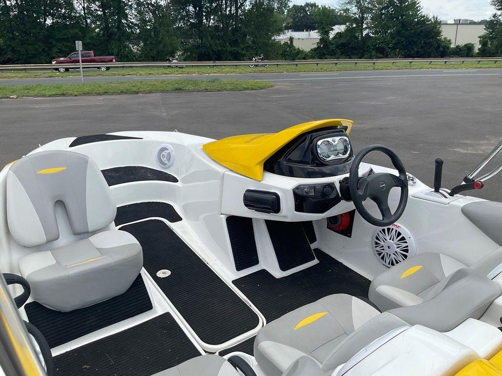 2009 Sea-Doo 150 Speedster 255 interior with yellow accents and steering wheel.