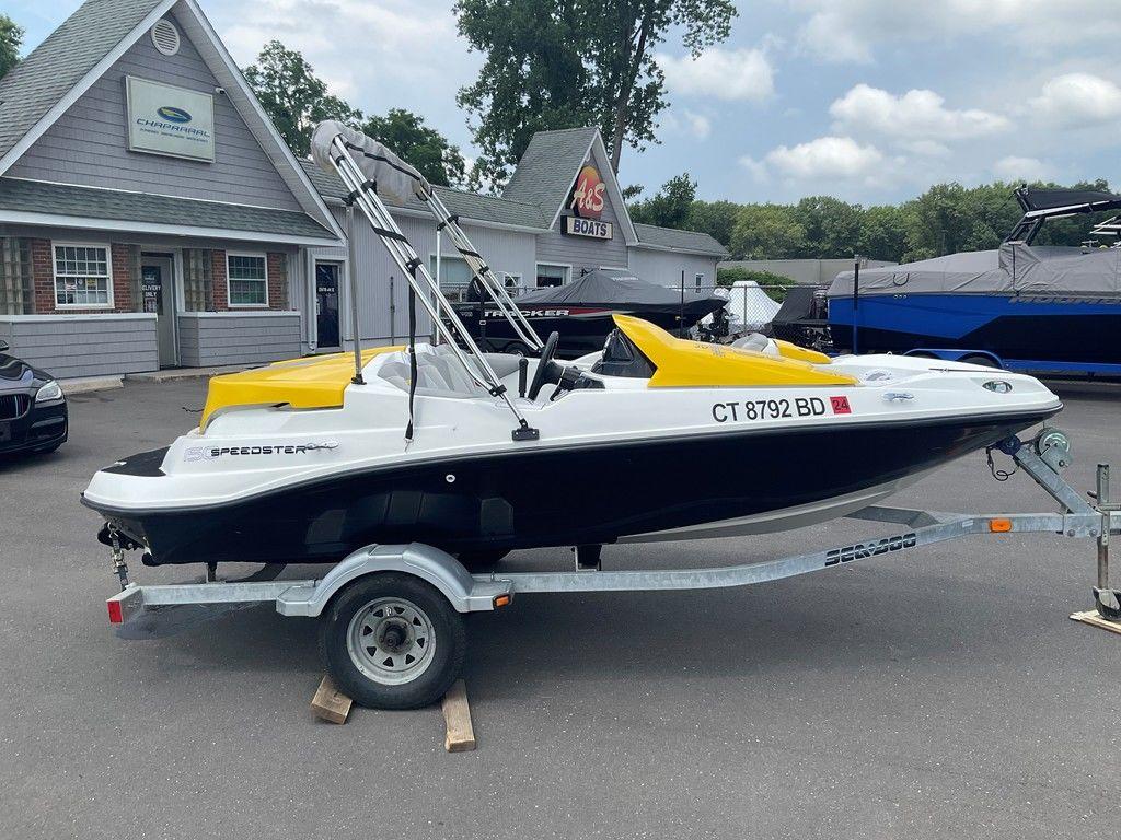 2009 Sea-Doo 150 Speedster 255 on trailer, parked outside a boat dealership.