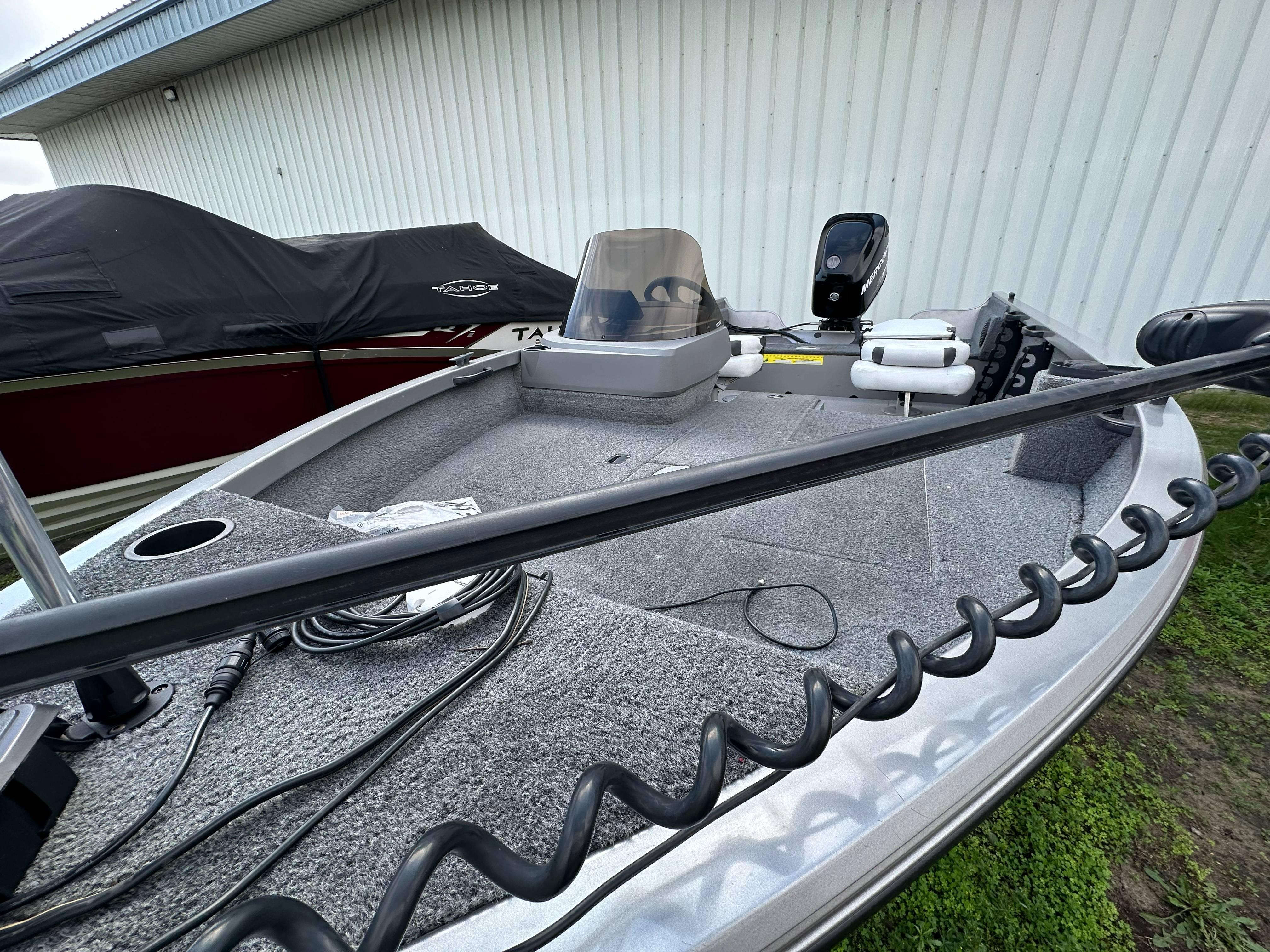 2013 Crestliner Fish Hawk 1650 SC boat, gray interior, parked outdoors.