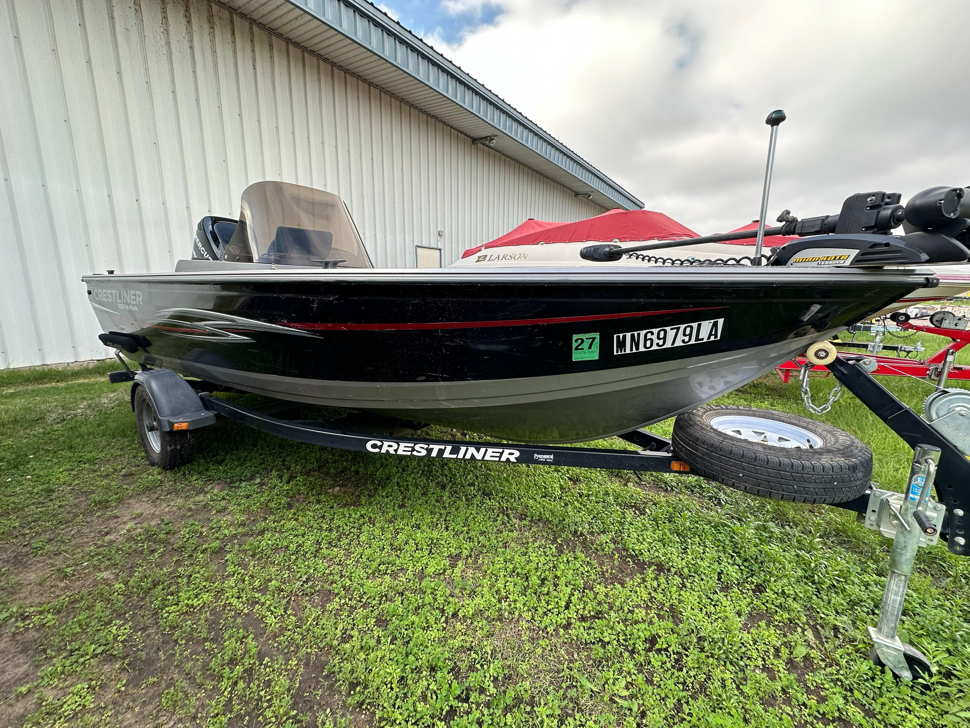 2013 Crestliner Fish Hawk 1650 SC boat on trailer, parked on grass.