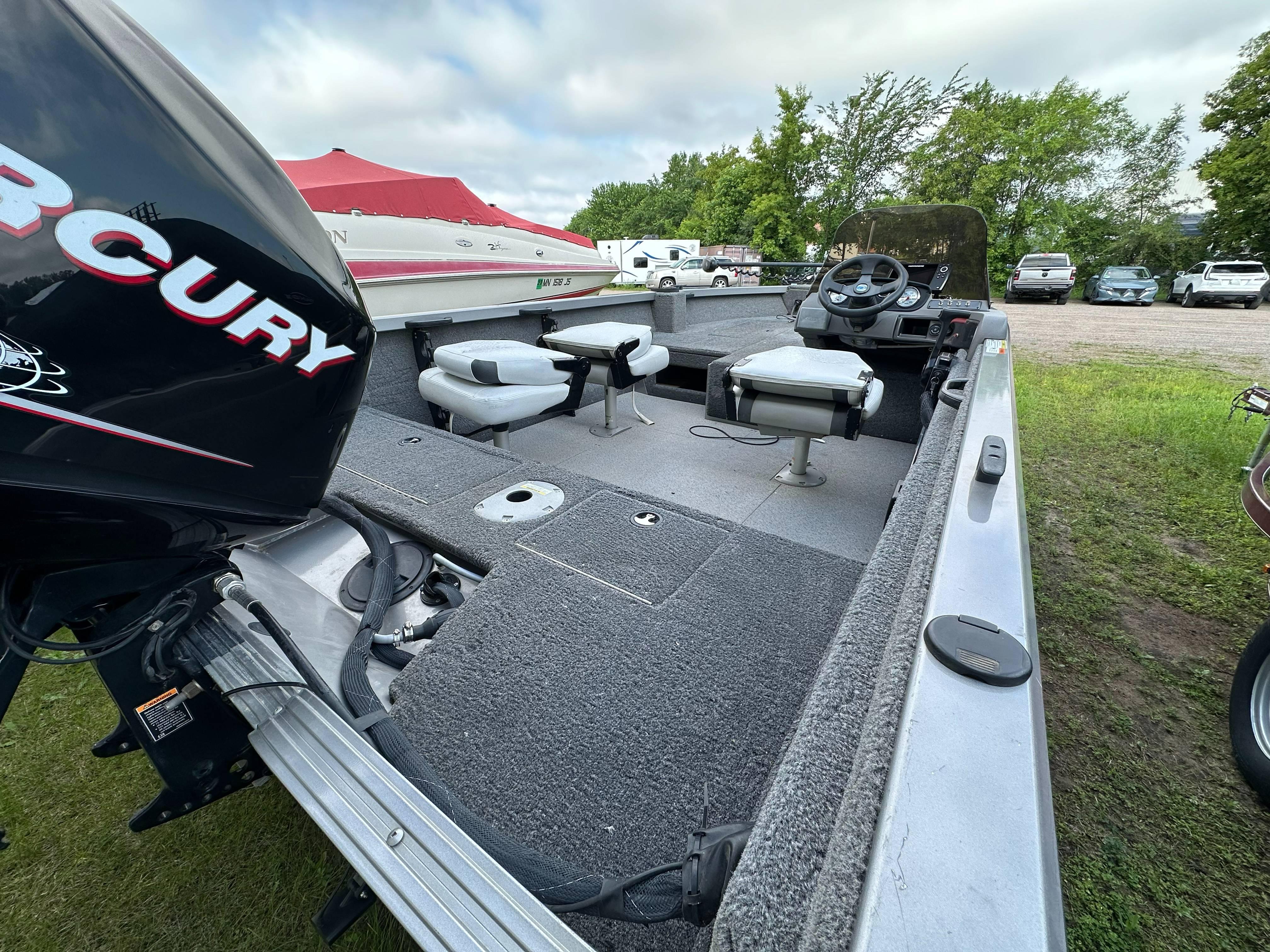 2013 Crestliner Fish Hawk 1650 SC boat with Mercury engine, featuring spacious interior and seating.