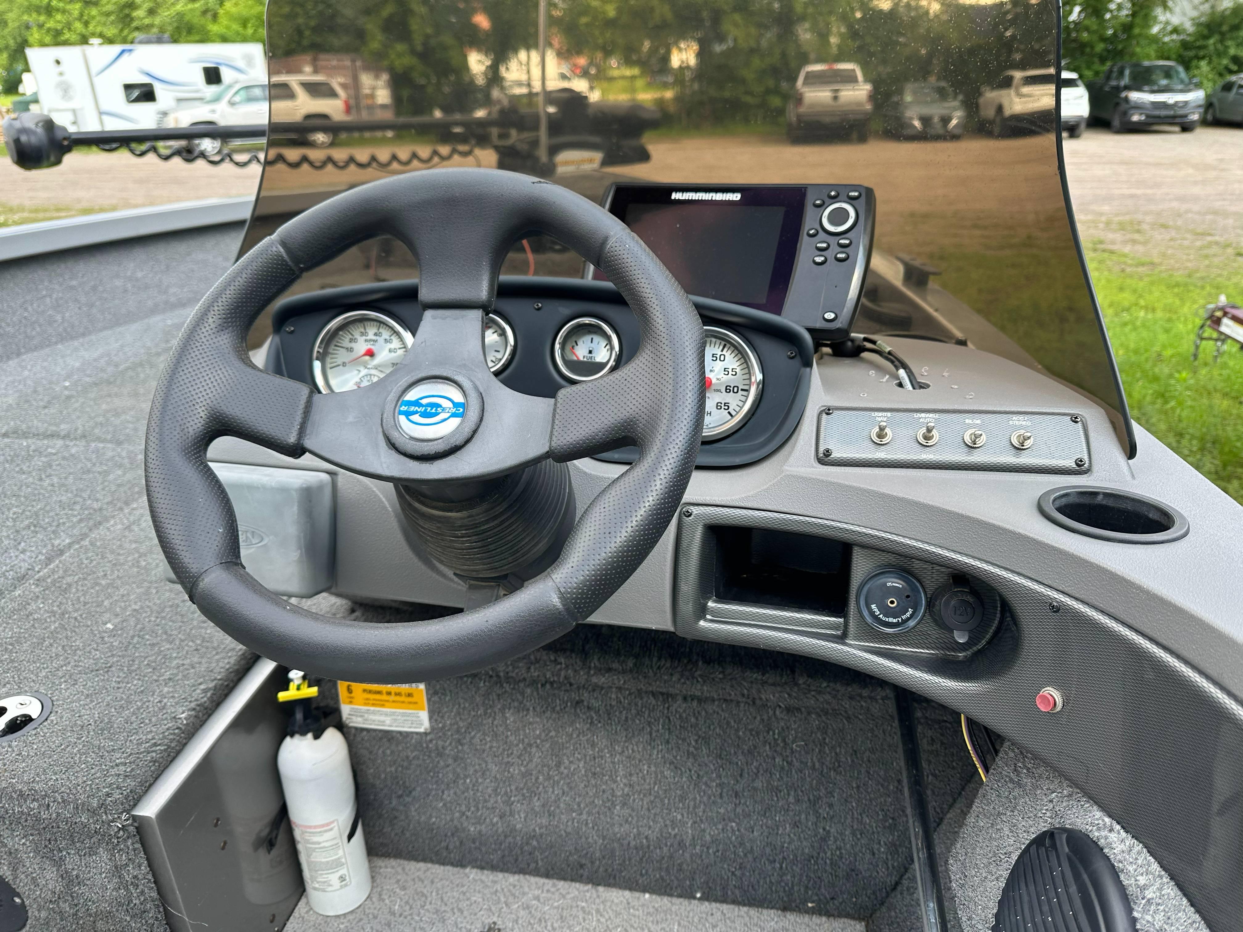 2013 Crestliner Fish Hawk 1650 SC dashboard with steering wheel and navigation controls.