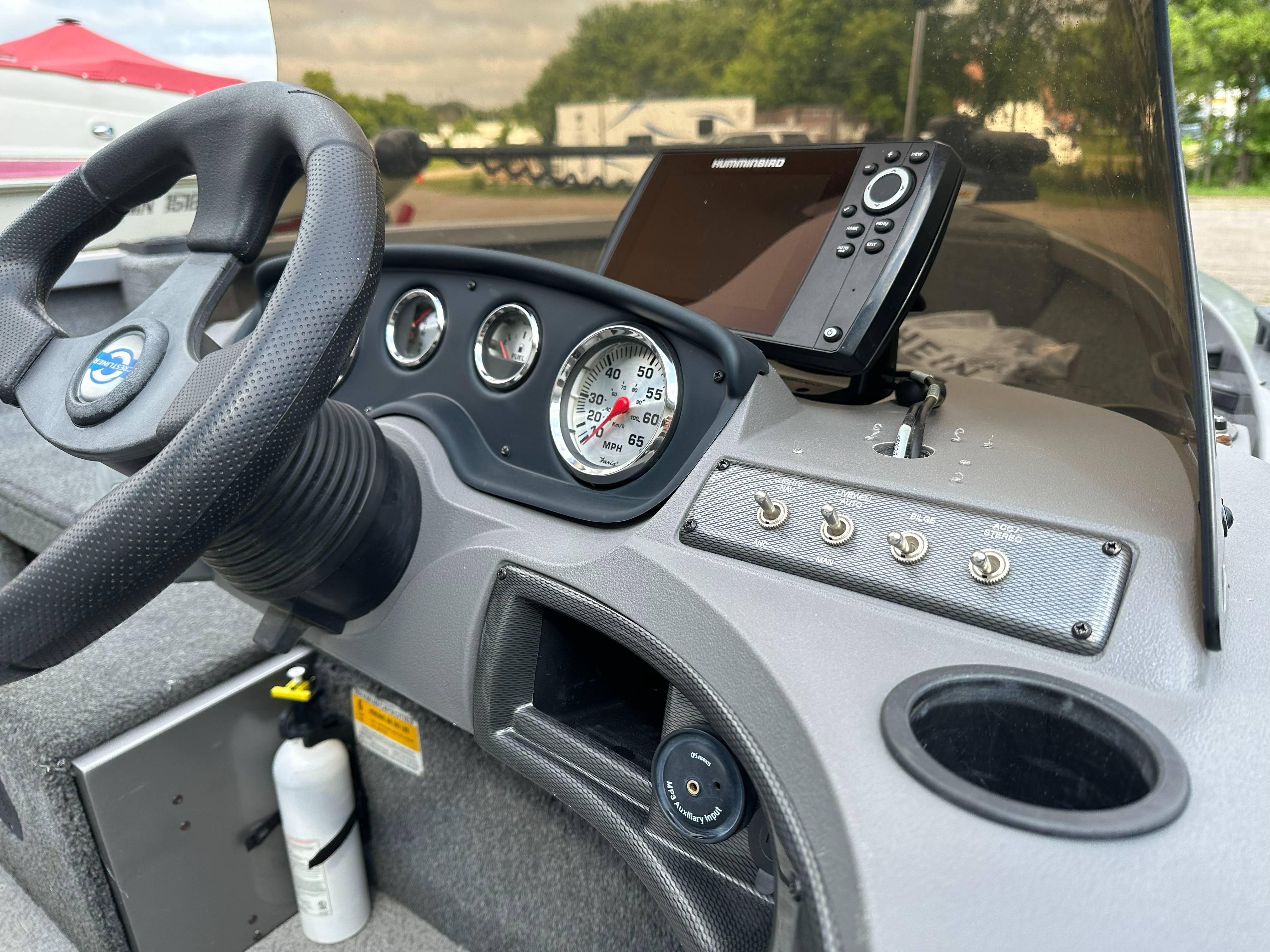 2013 Crestliner Fish Hawk 1650 SC dashboard with steering wheel and navigation system.