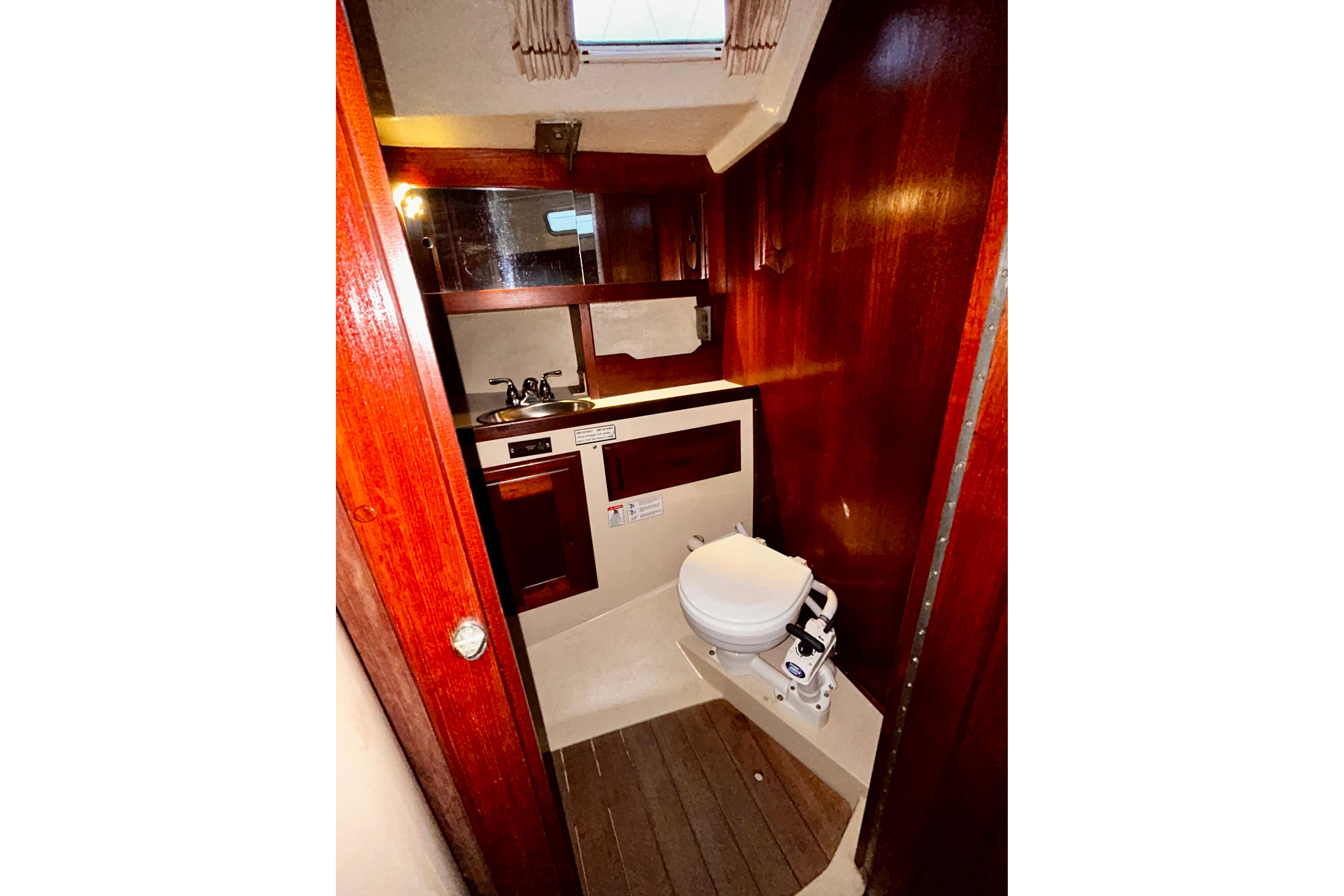 Forward Portside Head w/manual toilet.