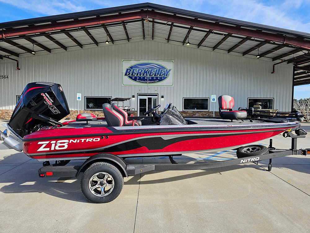 2025 Nitro Z18 boat in red and black, parked outside Berkeley Outdoors.