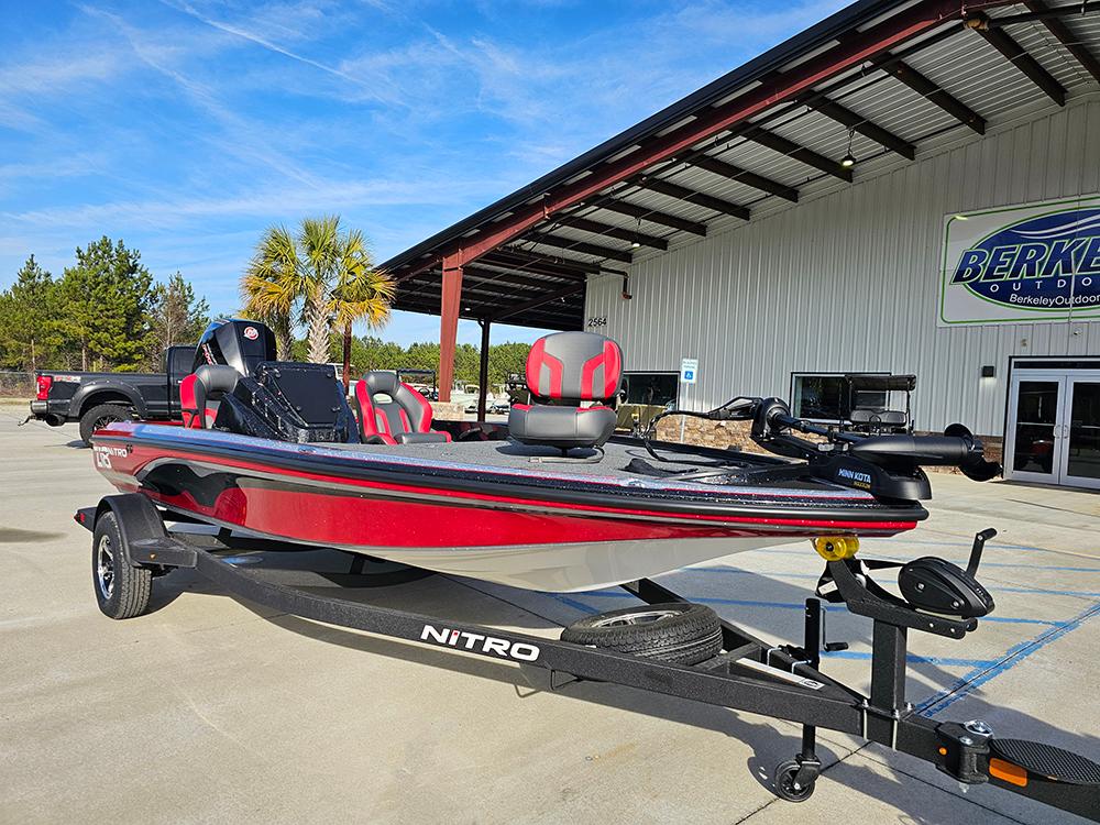 2025 Nitro Z18 boat in red and black, parked outside a dealership.