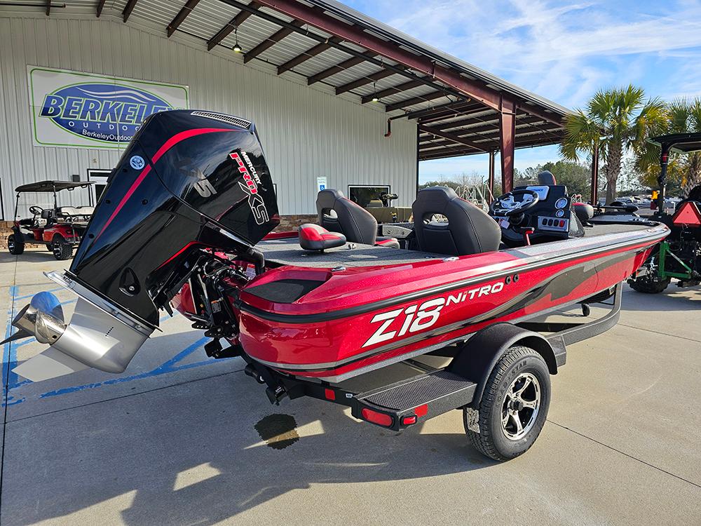 2025 Nitro Z18 boat in red, parked outdoors with a powerful outboard motor.