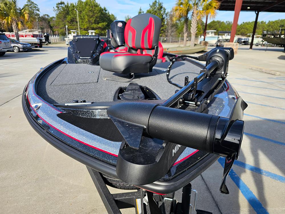 2025 Nitro Z18 fishing boat with red and gray seating, parked outdoors.
