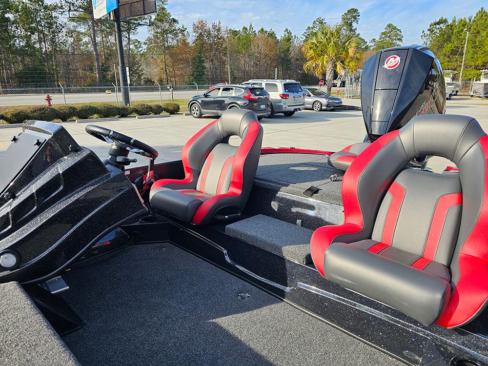 2025 Nitro Z18 boat with red and gray seats, parked outdoors.
