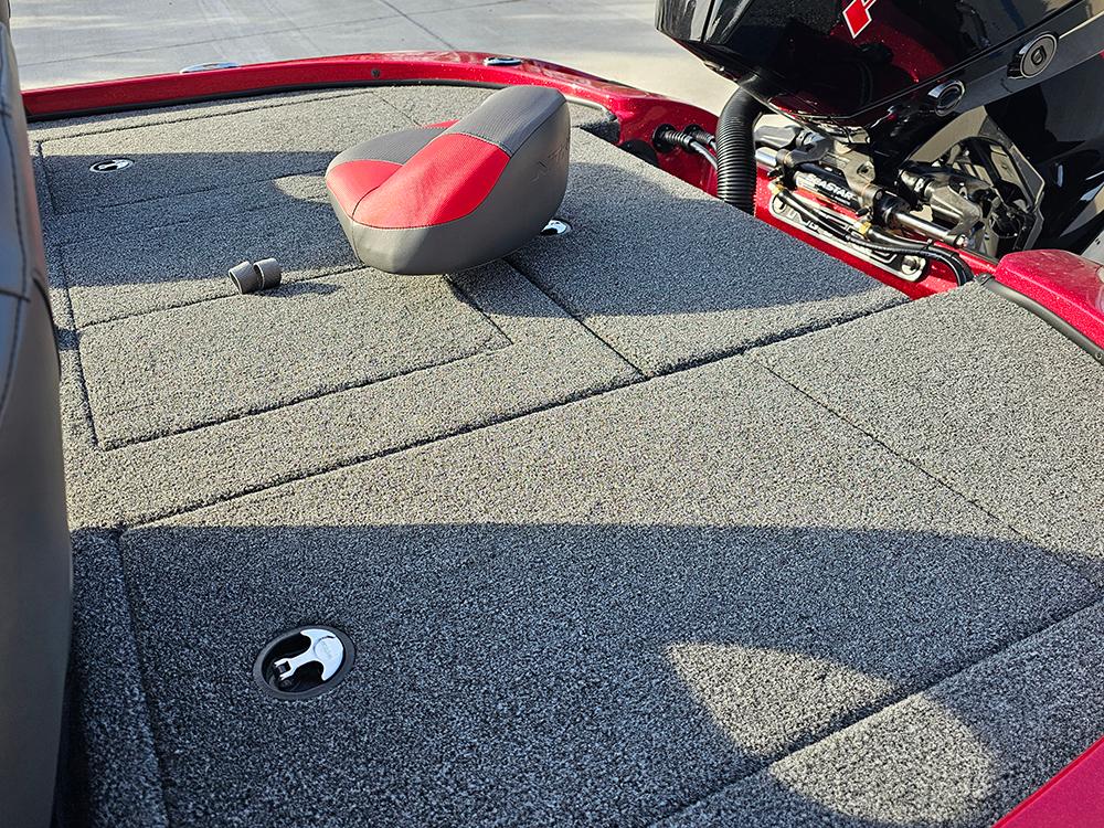 2025 Nitro Z18 boat deck with gray carpet and red seat.