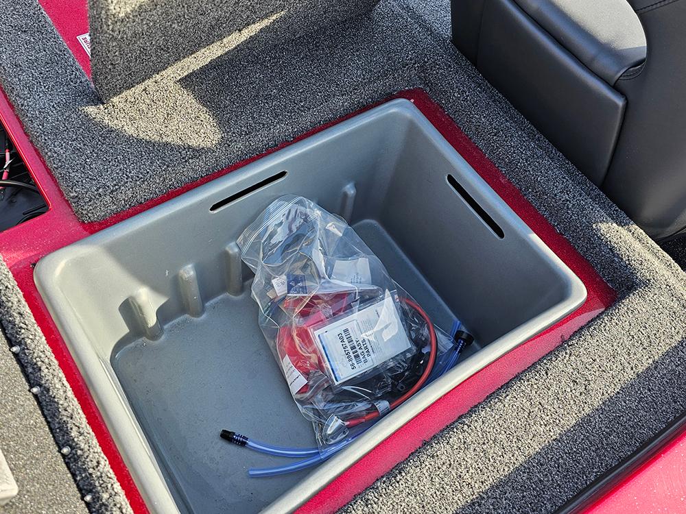Storage compartment in a 2025 Nitro Z18 boat with accessories inside.