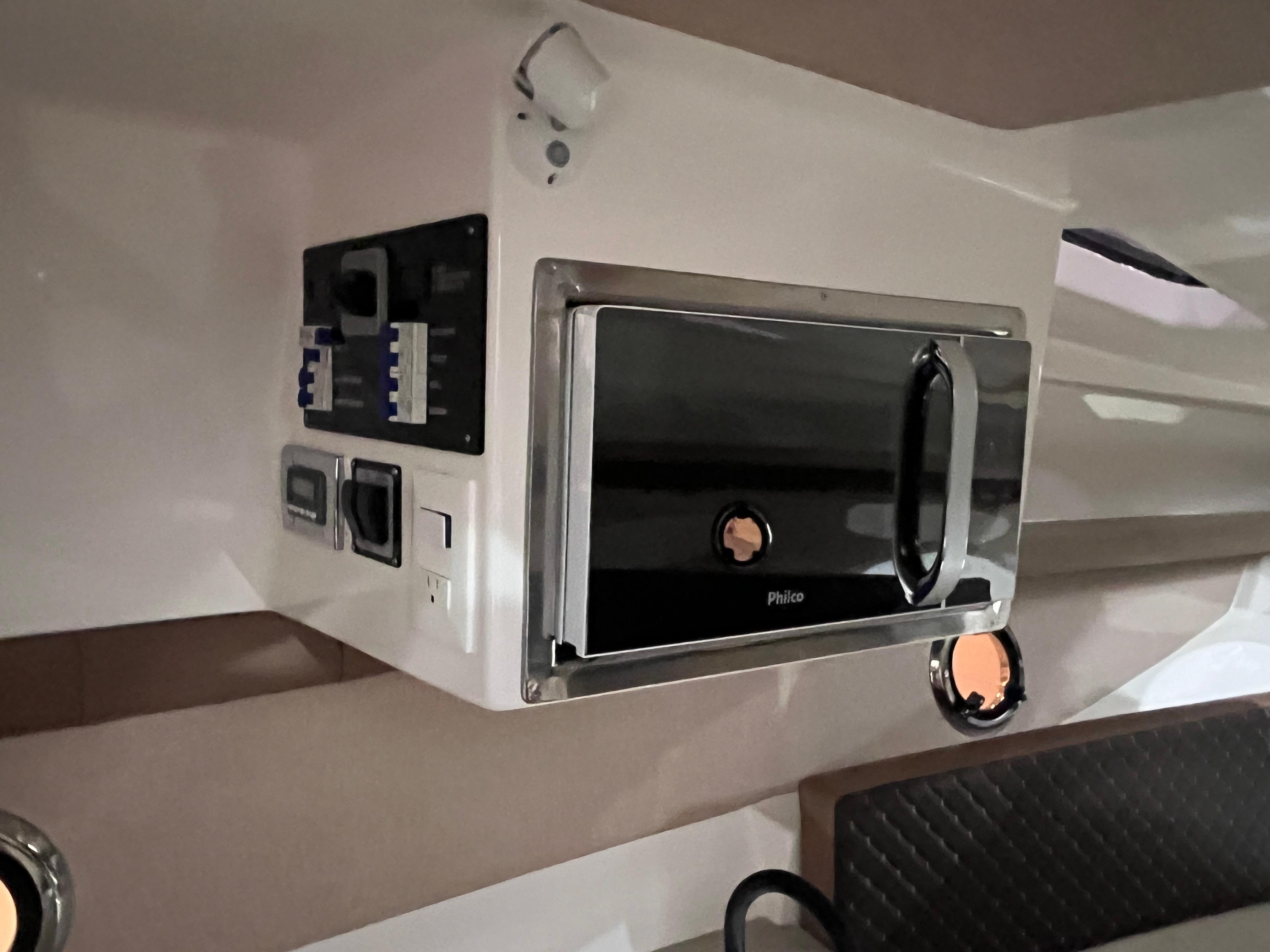 Ventura-DayCruiser 2025 -FL-US-Interior of 2025 Ventura DayCruiser featuring a modern microwave and control panel.-9681900 | Thumbnail