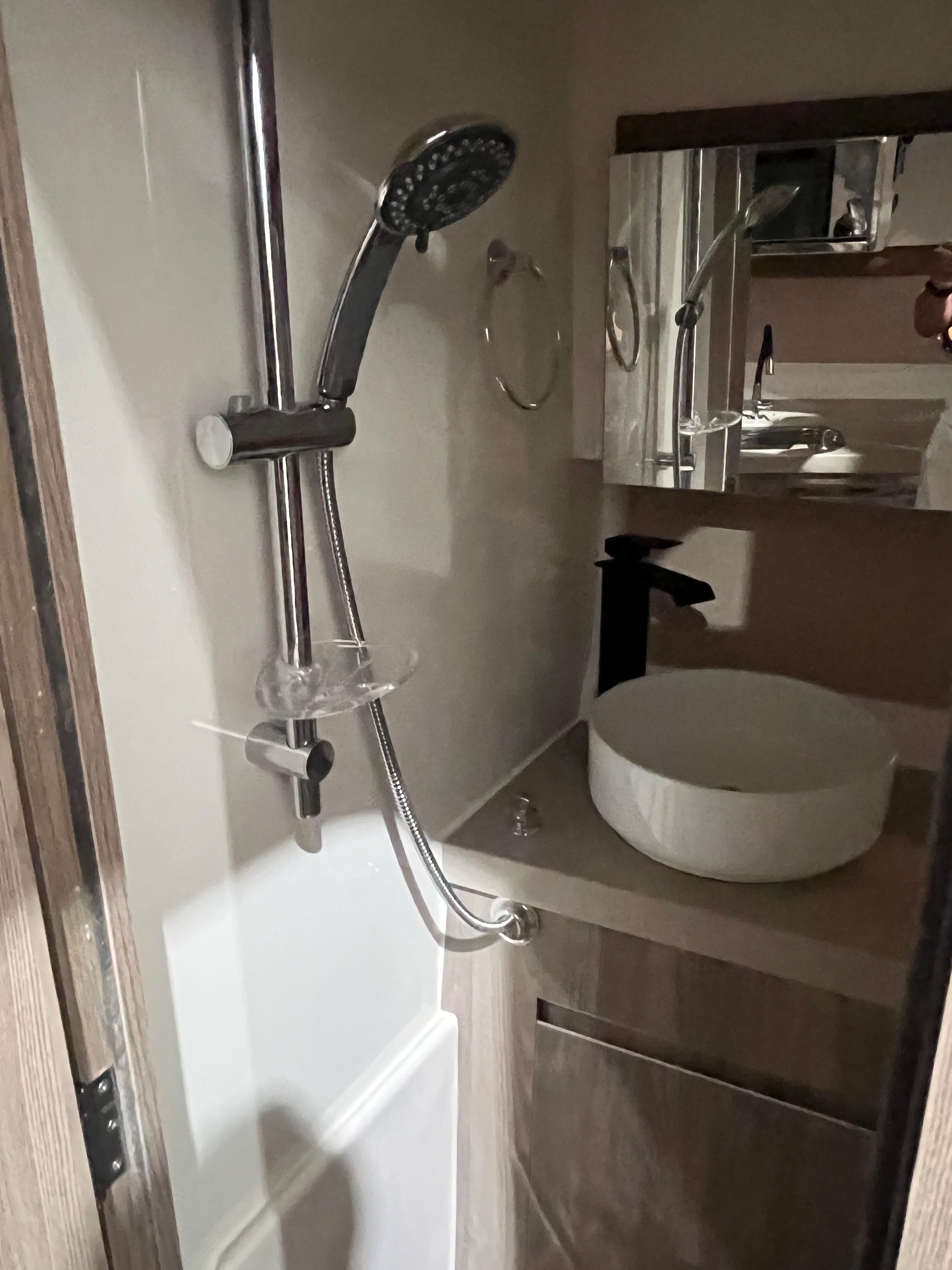 Ventura-DayCruiser 2025 -FL-US-Compact bathroom in 2025 Ventura DayCruiser with modern shower and sink design.-9681900 | Thumbnail