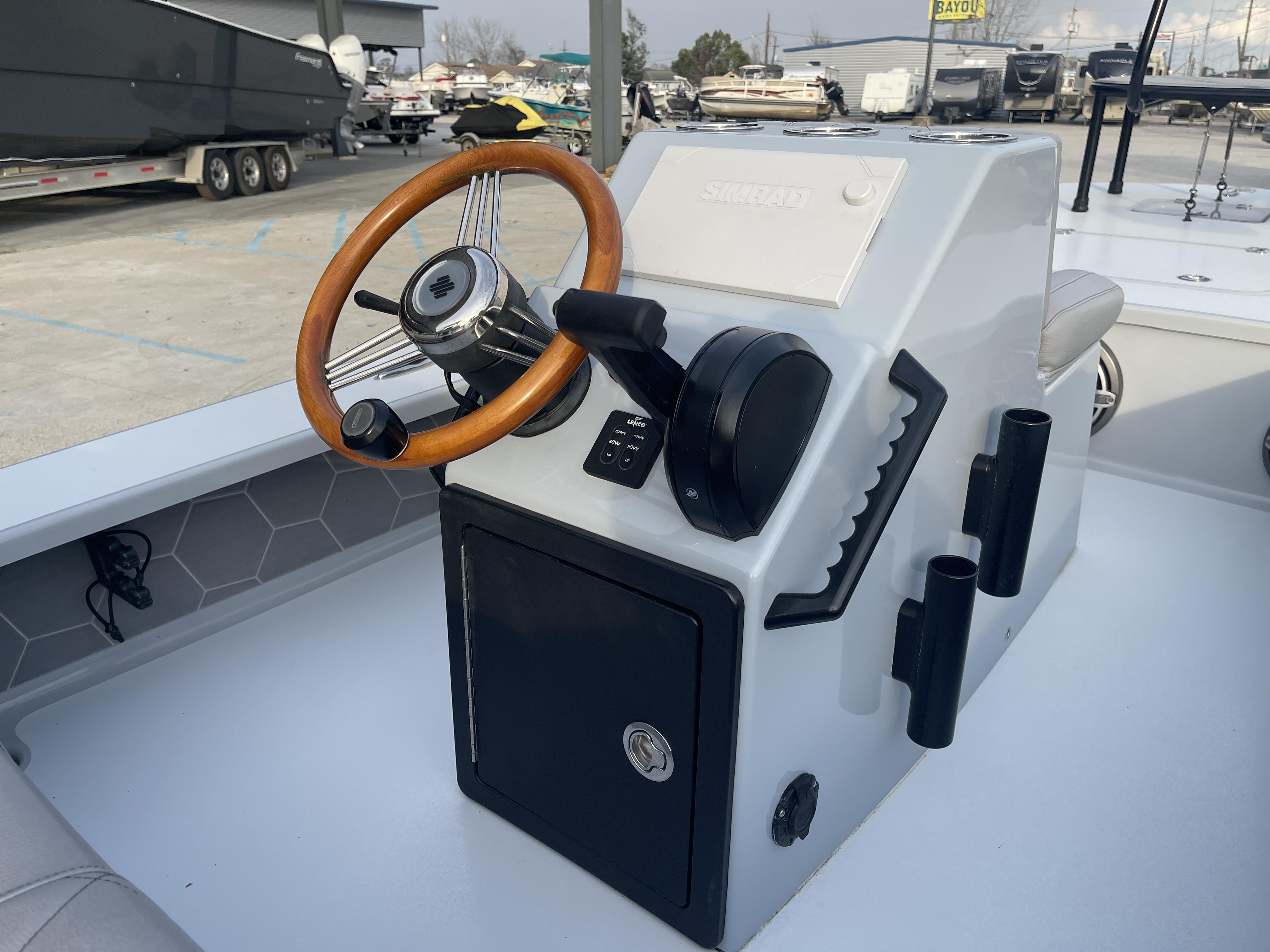 2023 ZCB 18 Curlew boat console with wooden steering wheel and control panel.