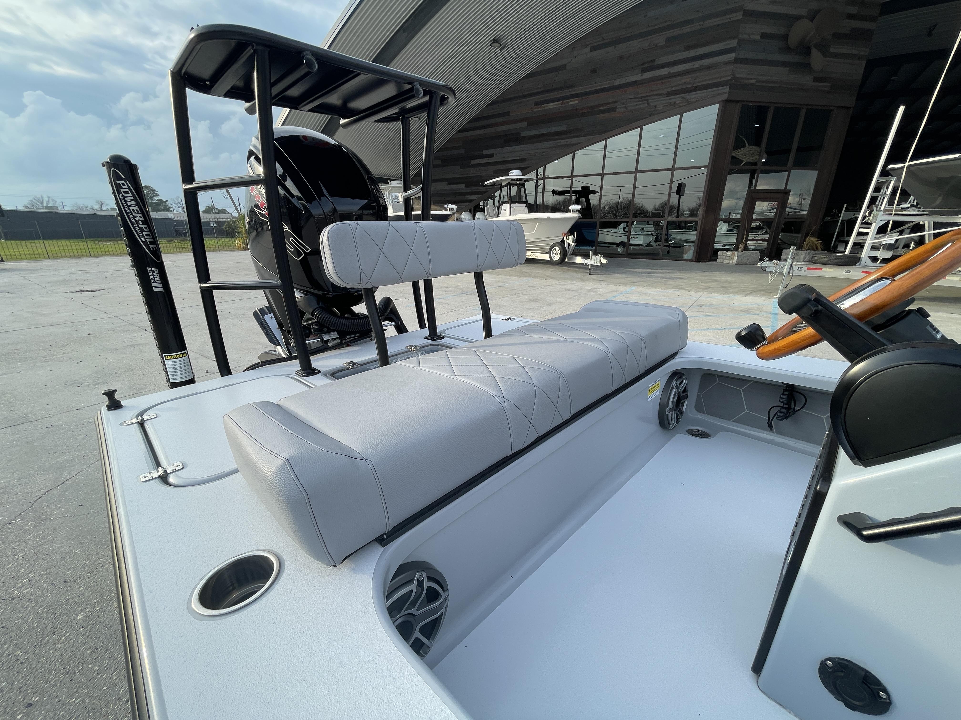 2023 ZCB 18 Curlew boat interior with cushioned seating and steering wheel.