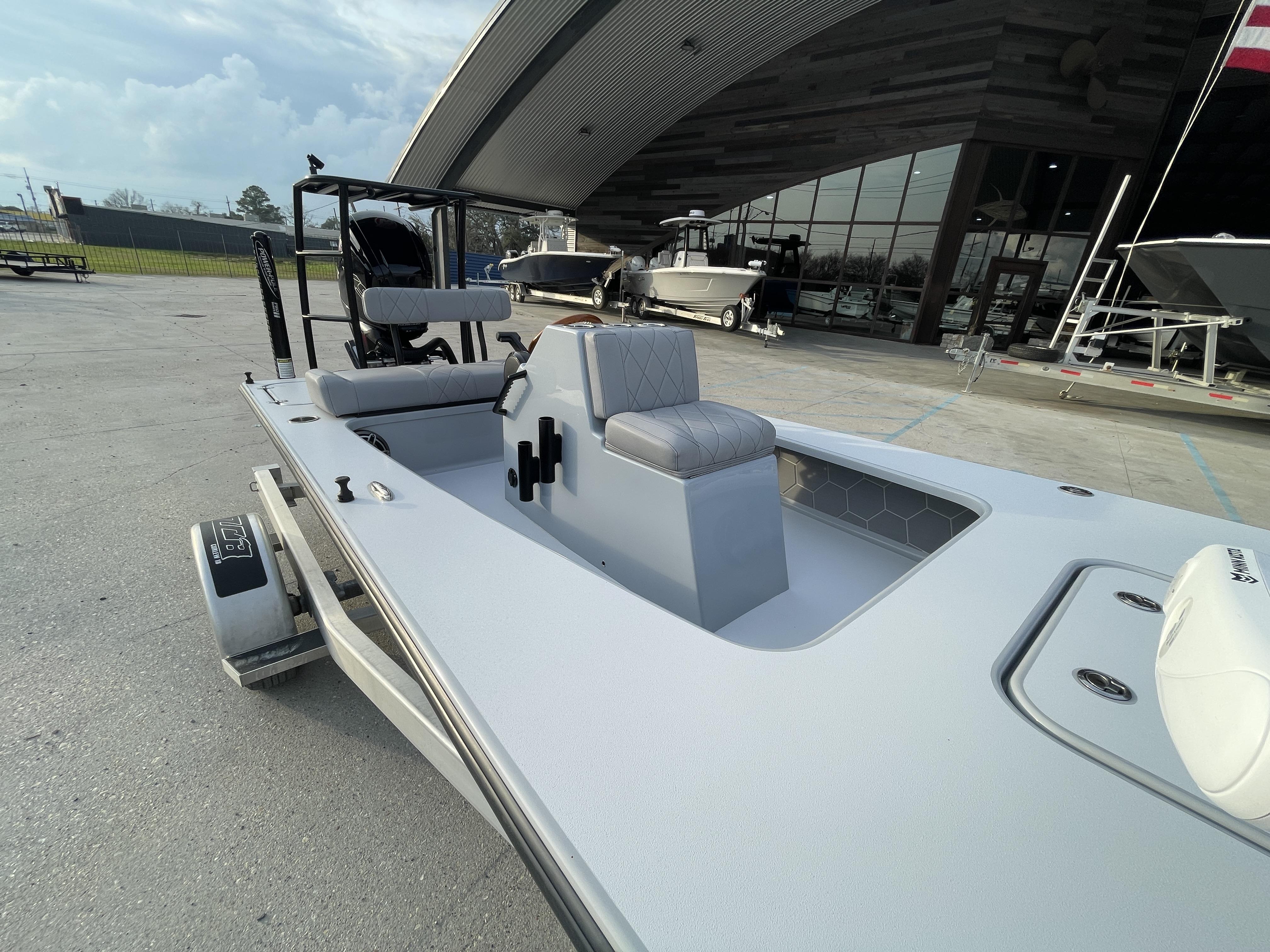 2023 ZCB 18 Curlew boat displayed at a dealership, showcasing sleek design and seating.