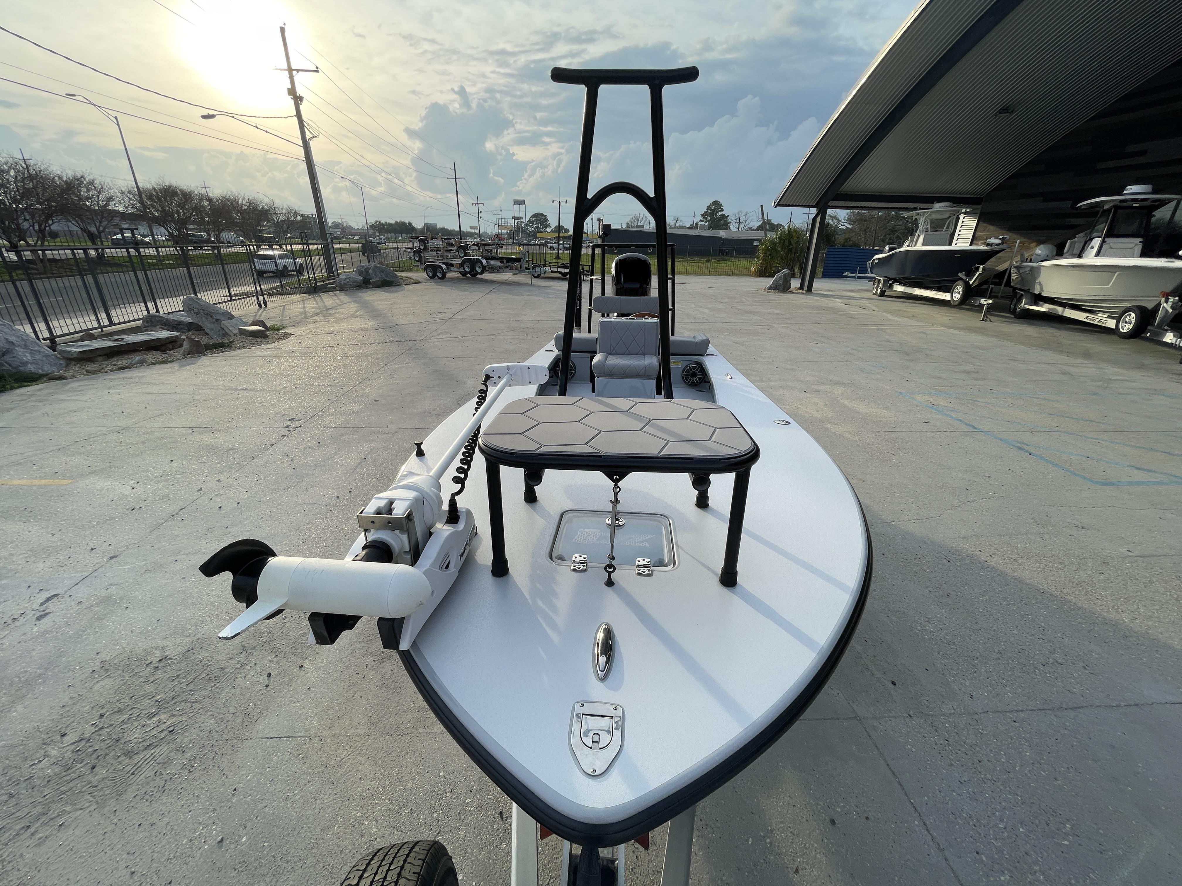 2023 ZCB 18 Curlew boat on display at a dealership under a cloudy sky.