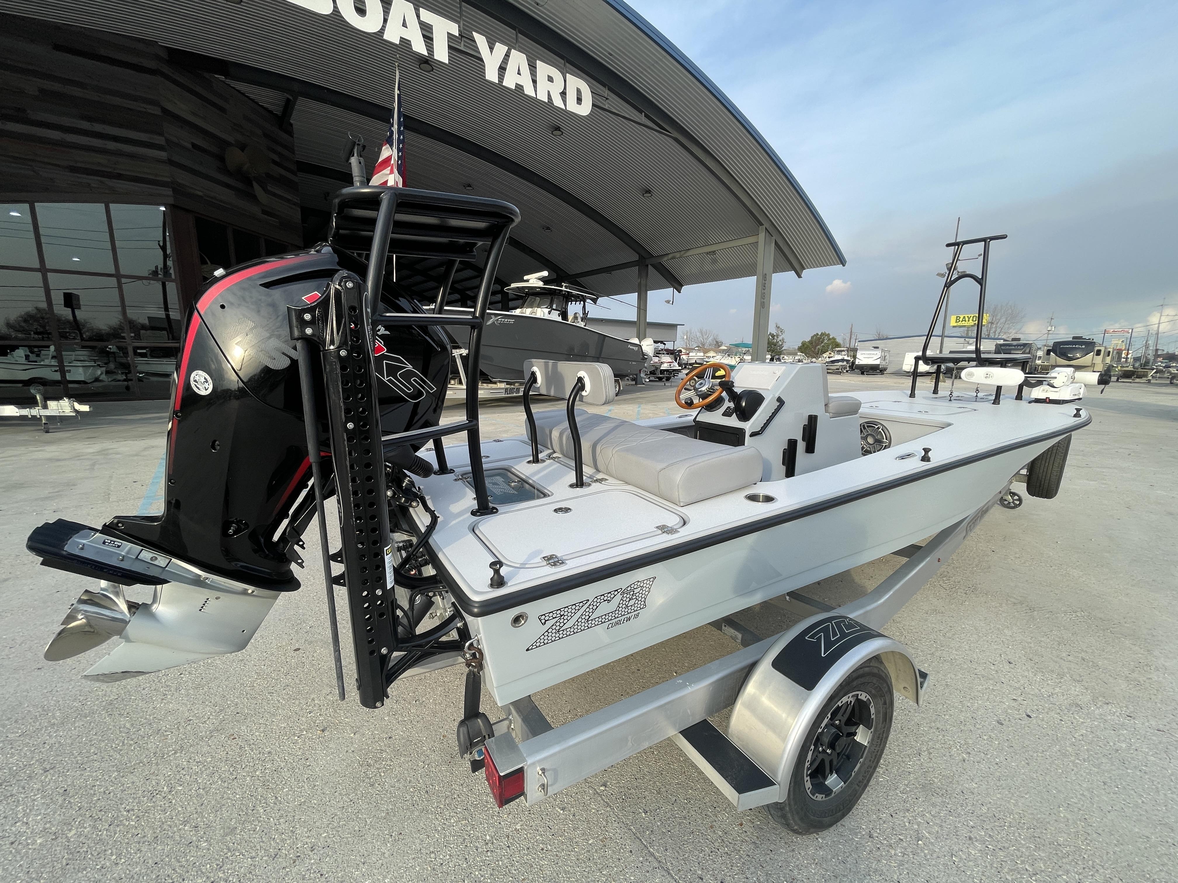 2023 ZCB 18 Curlew boat at a boat yard, featuring a sleek design and powerful engine.