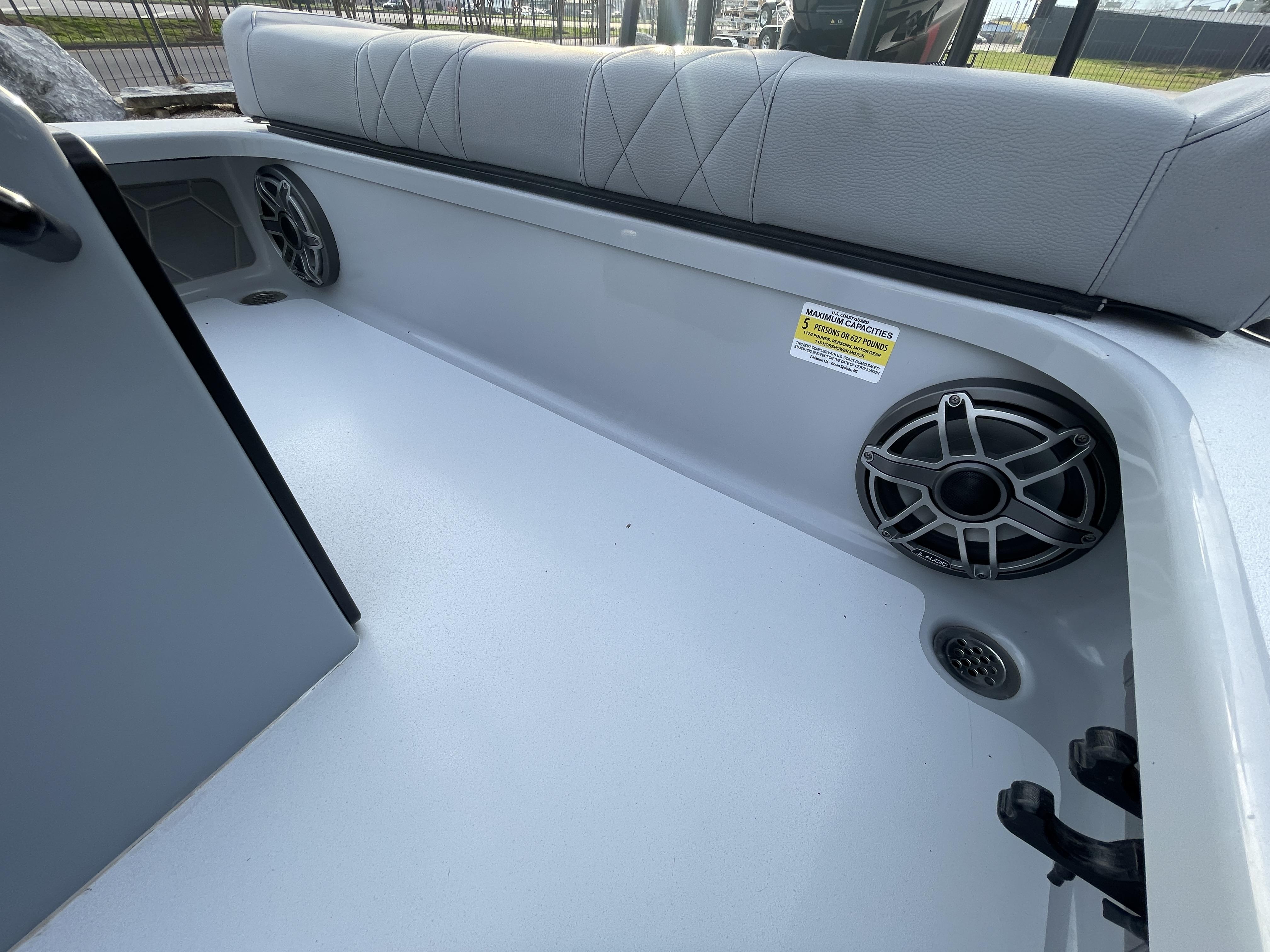 Interior of 2023 ZCB 18 Curlew boat with seating and speaker system.