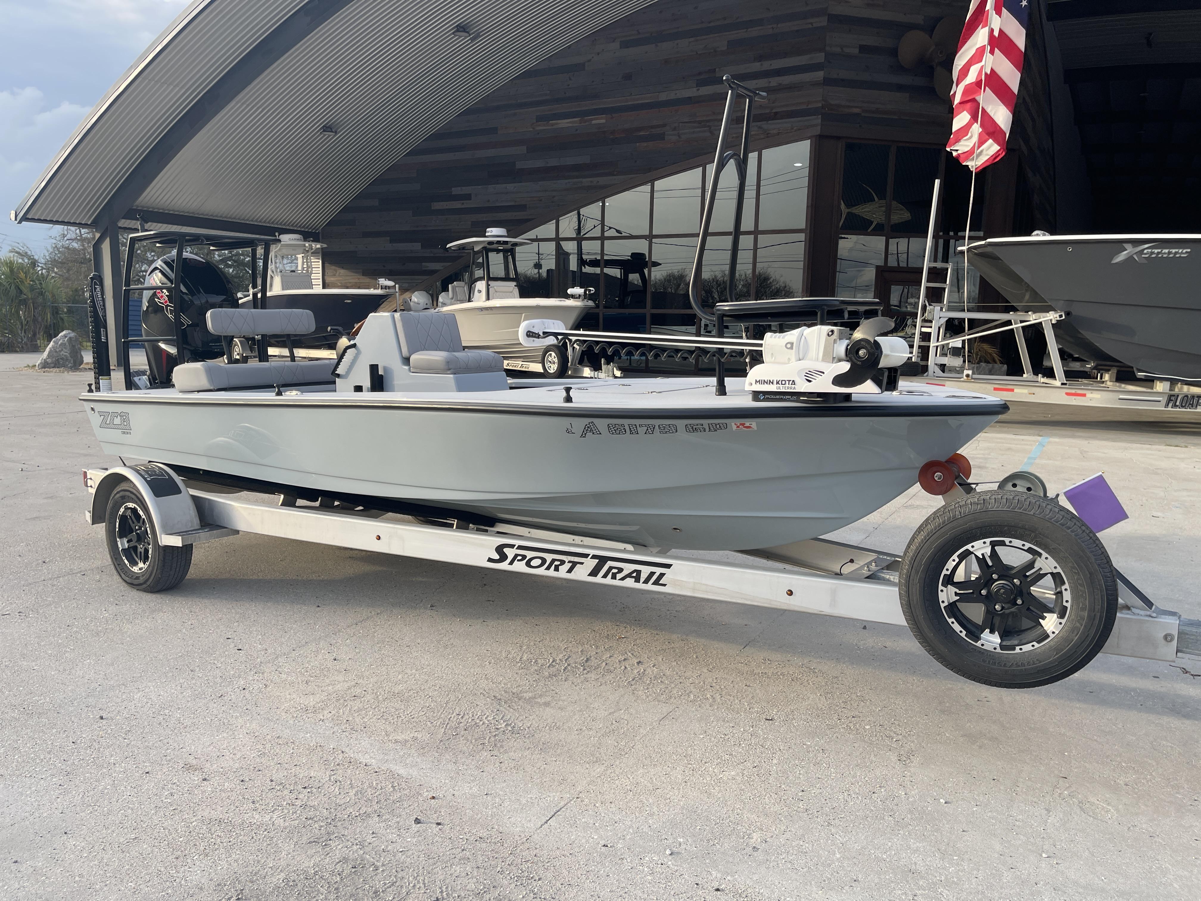 2023 ZCB 18 Curlew boat on Sport Trail trailer, parked outdoors.