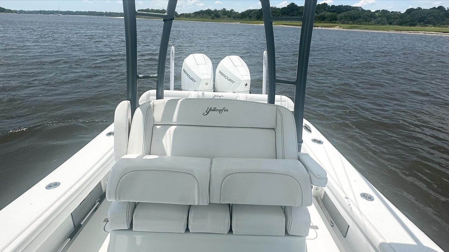 2020 Yellowfin 26 Hybrid boat with dual Mercury engines on a calm waterway.