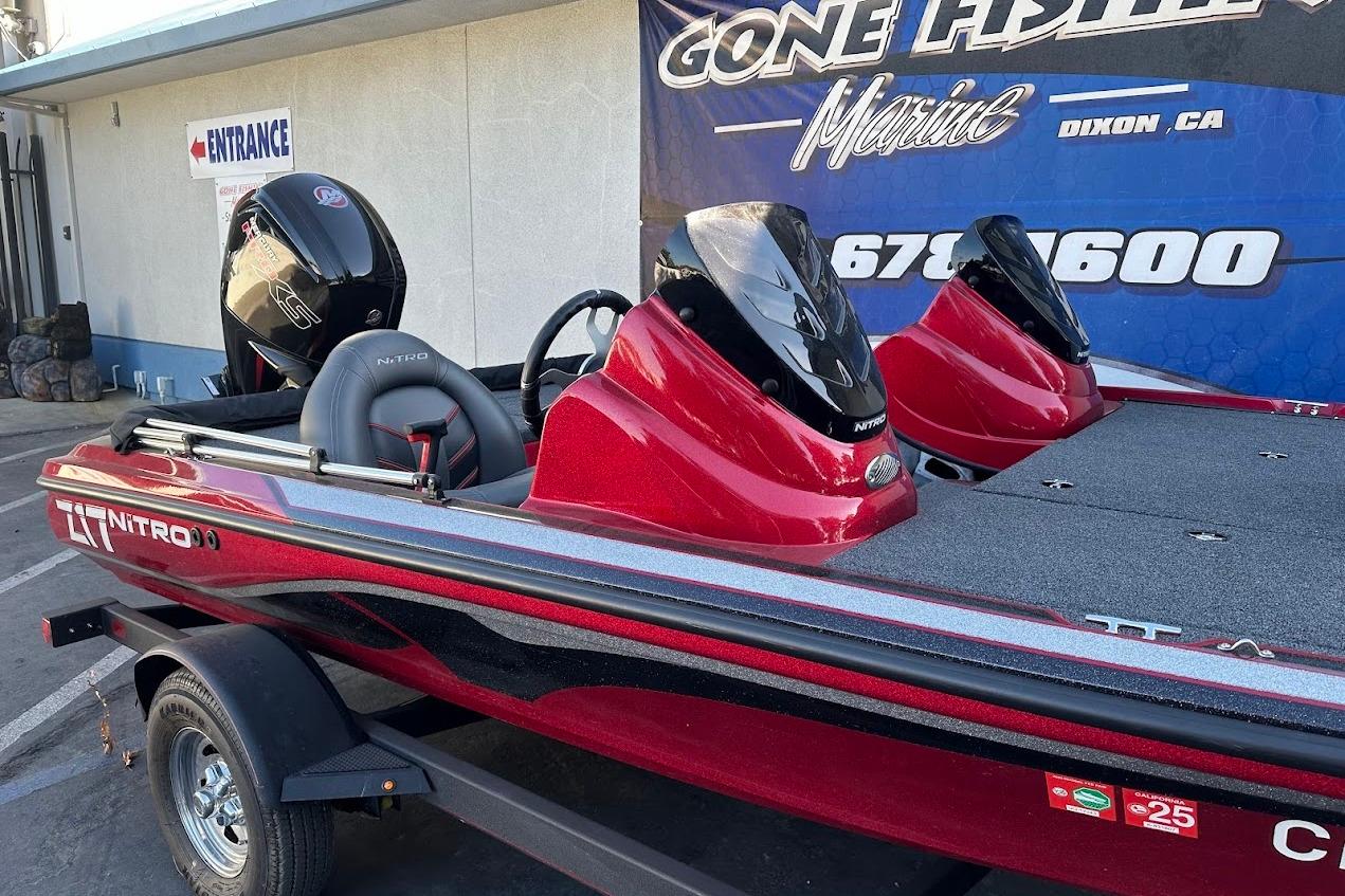 2024 Nitro Z17 boat in red, displayed at a marine dealership.