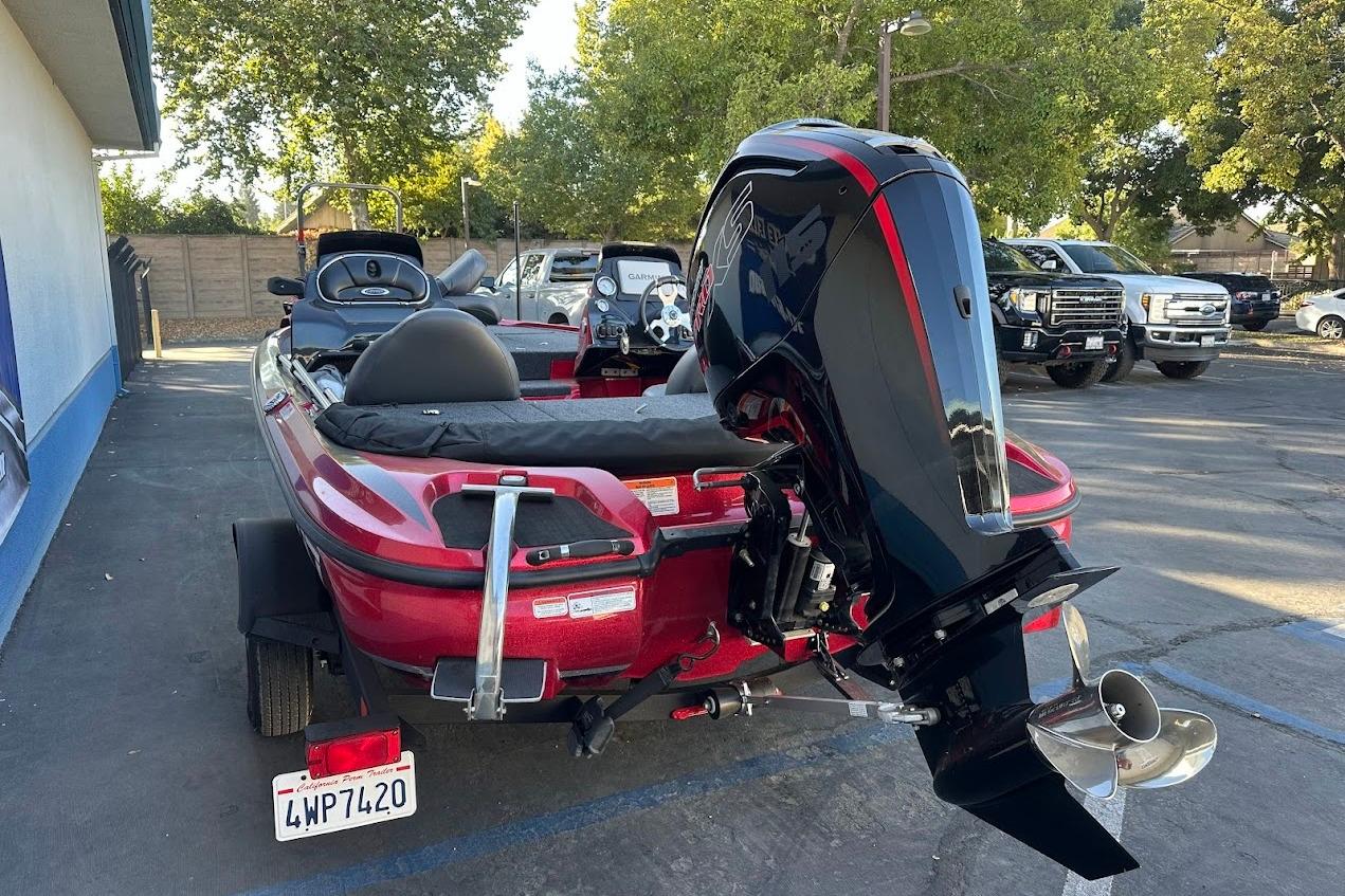 2024 Nitro Z17 boat with powerful outboard motor in parking lot.