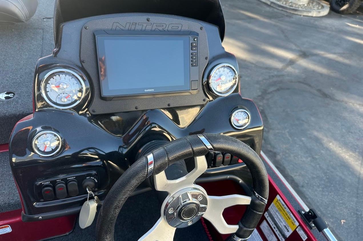 2024 Nitro Z17 boat dashboard with steering wheel and digital display.
