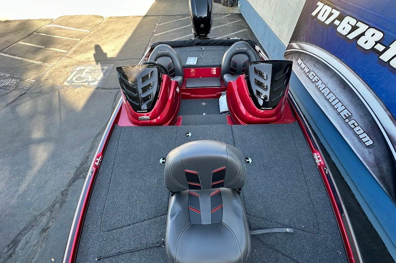 2024 Nitro Z17 boat interior with seating and control panels, parked near a building.
