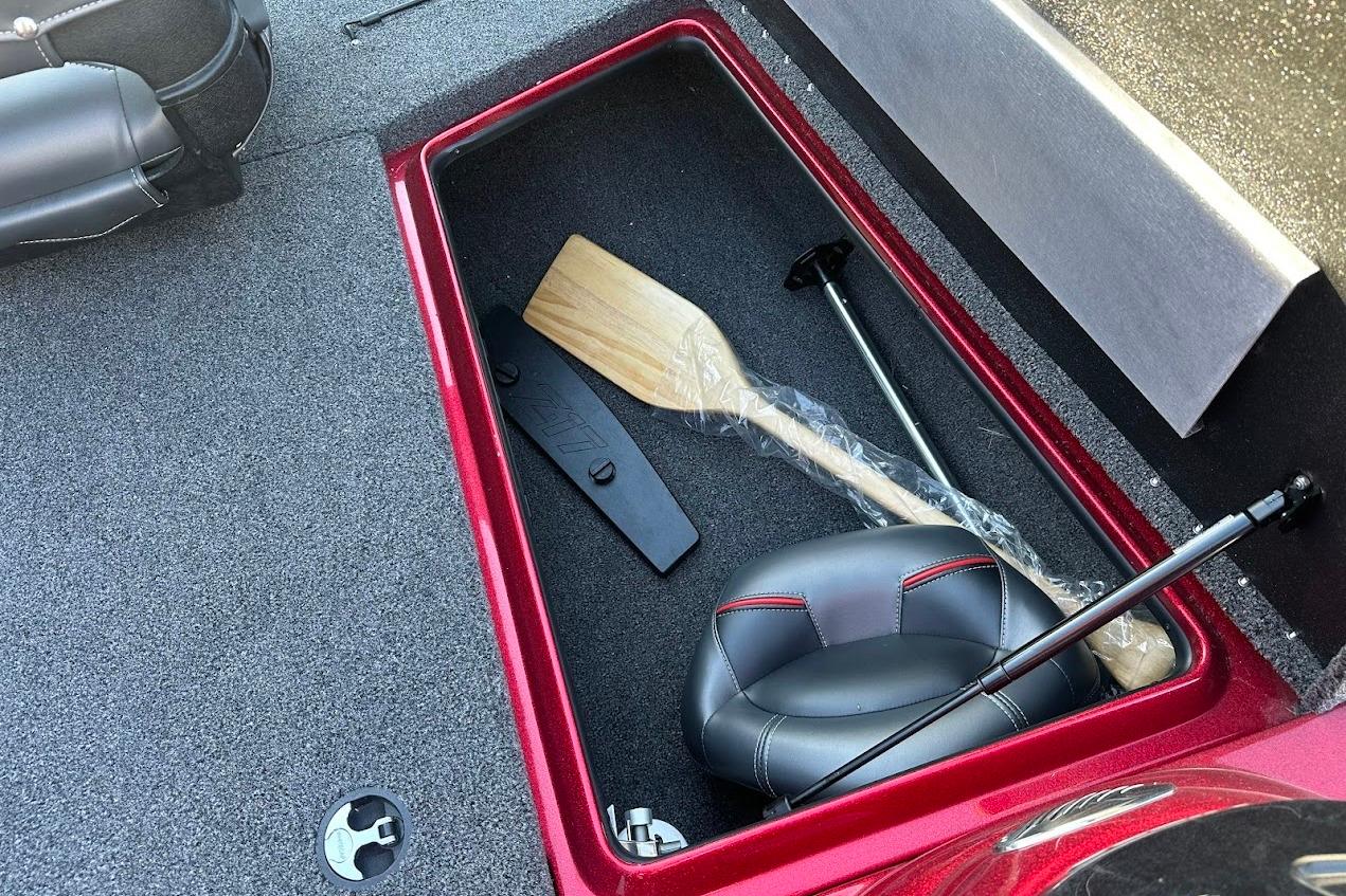 2024 Nitro Z17 storage compartment with paddle and seat, featuring red trim.