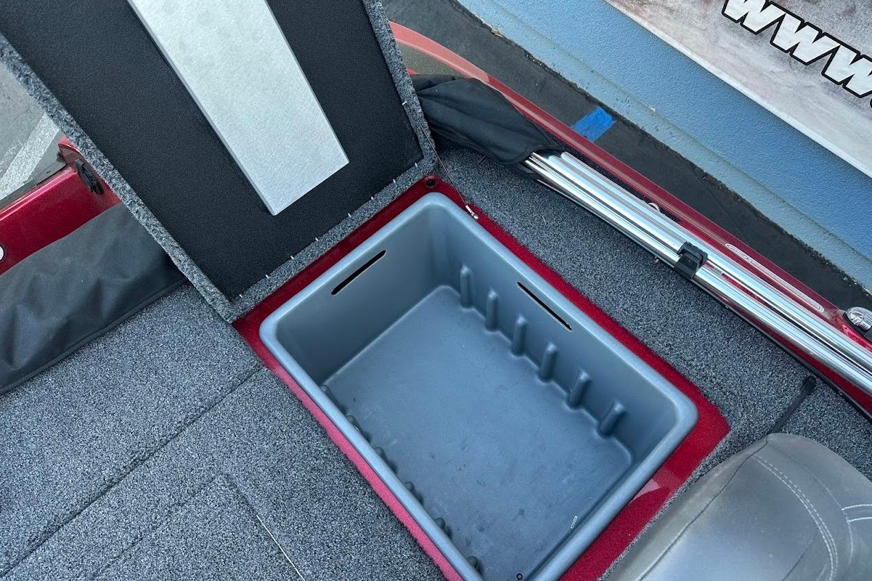 Open storage compartment in 2024 Nitro Z17 boat, featuring carpeted interior and sleek design.