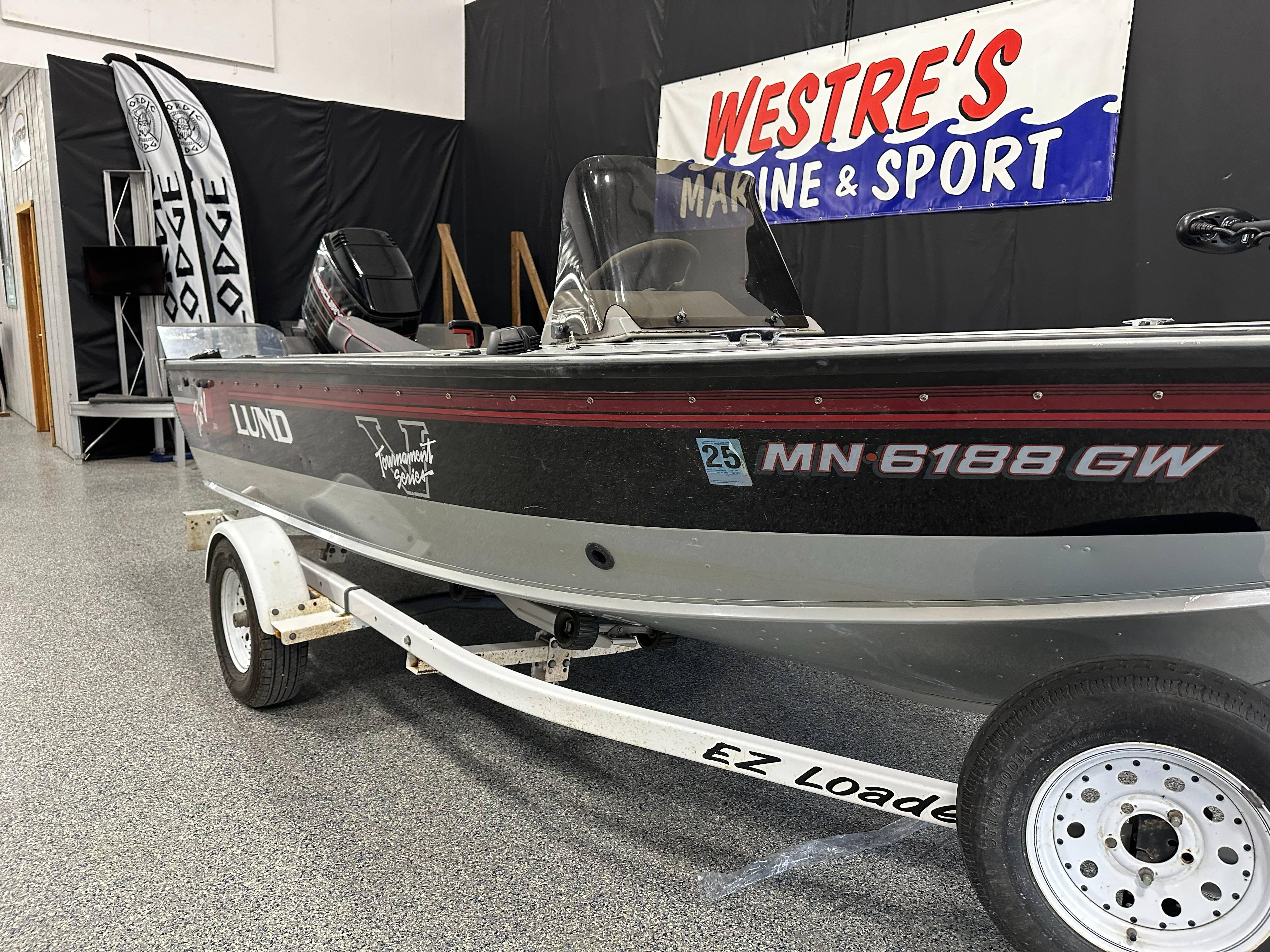 1995 Lund 1650 DLX boat on trailer at Westre's Marine & Sport showroom.