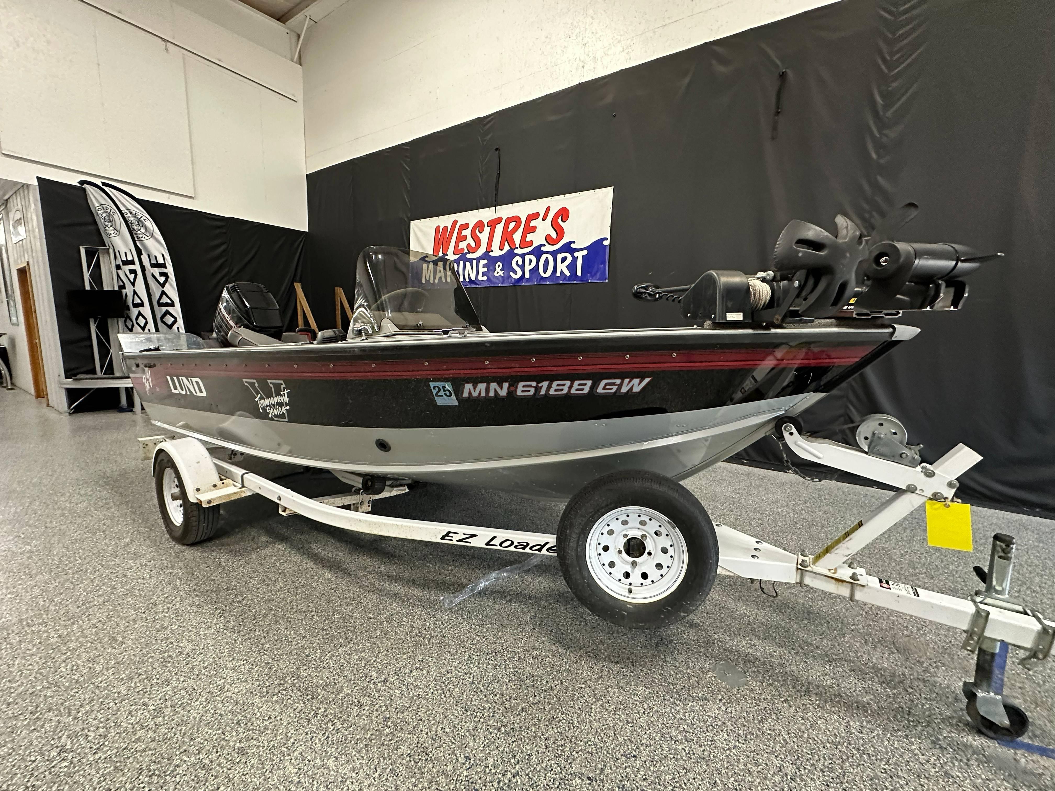 1995 Lund 1650 DLX fishing boat on trailer at Westre's Marine & Sport showroom.