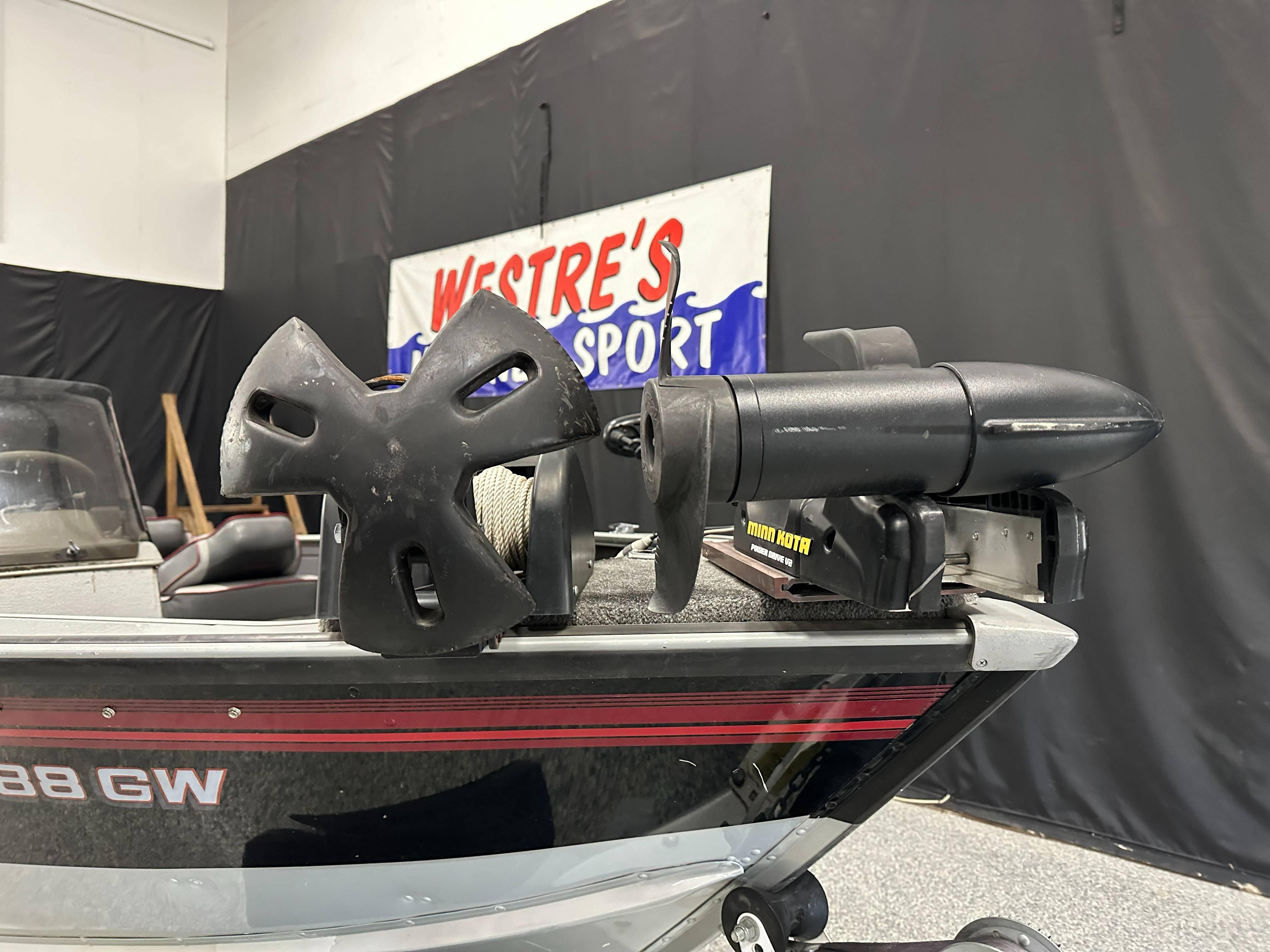 1995 Lund 1650 DLX boat with Minn Kota trolling motor in showroom.