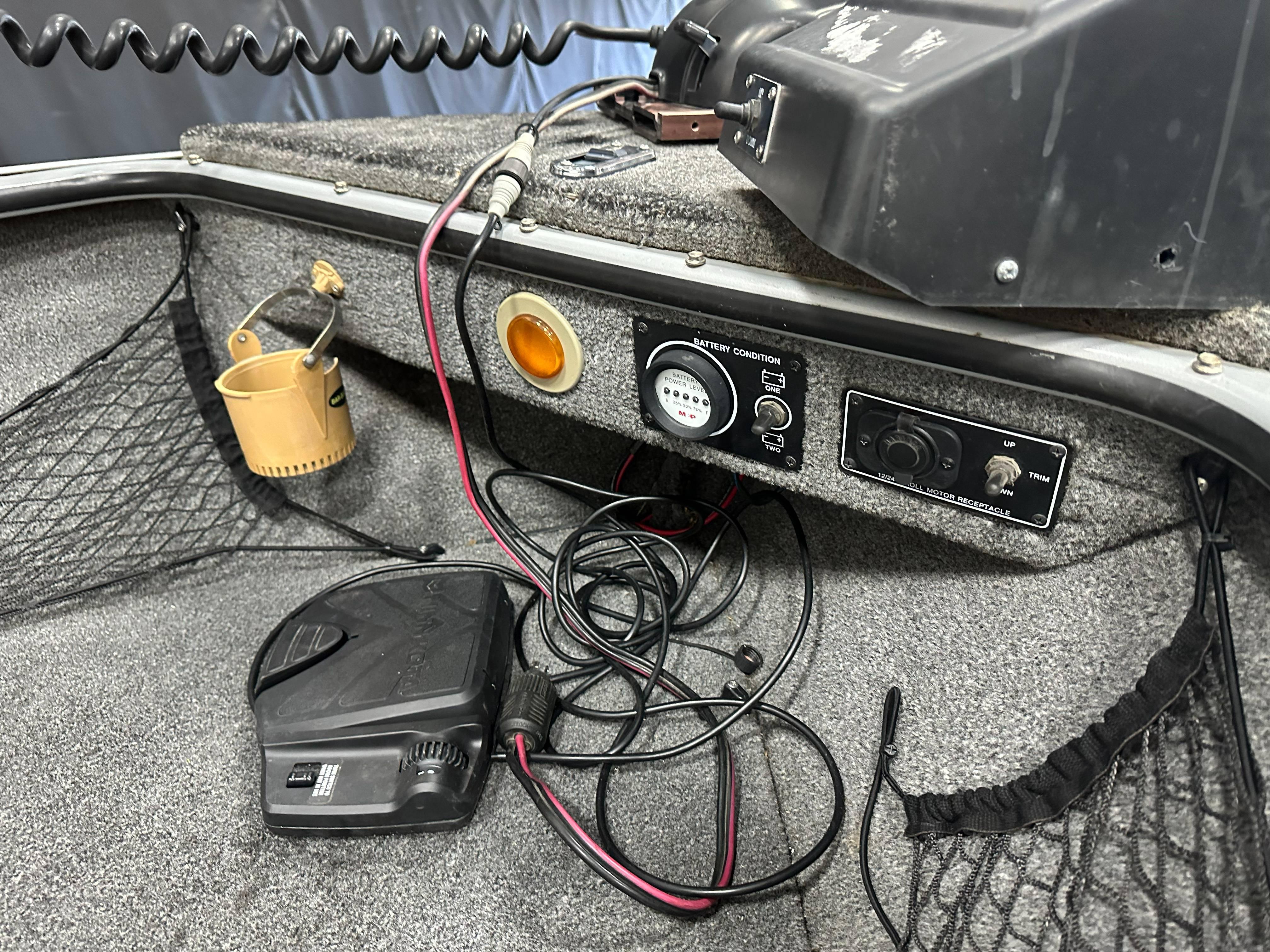 1995 Lund 1650 DLX boat dashboard with wiring and control panel.