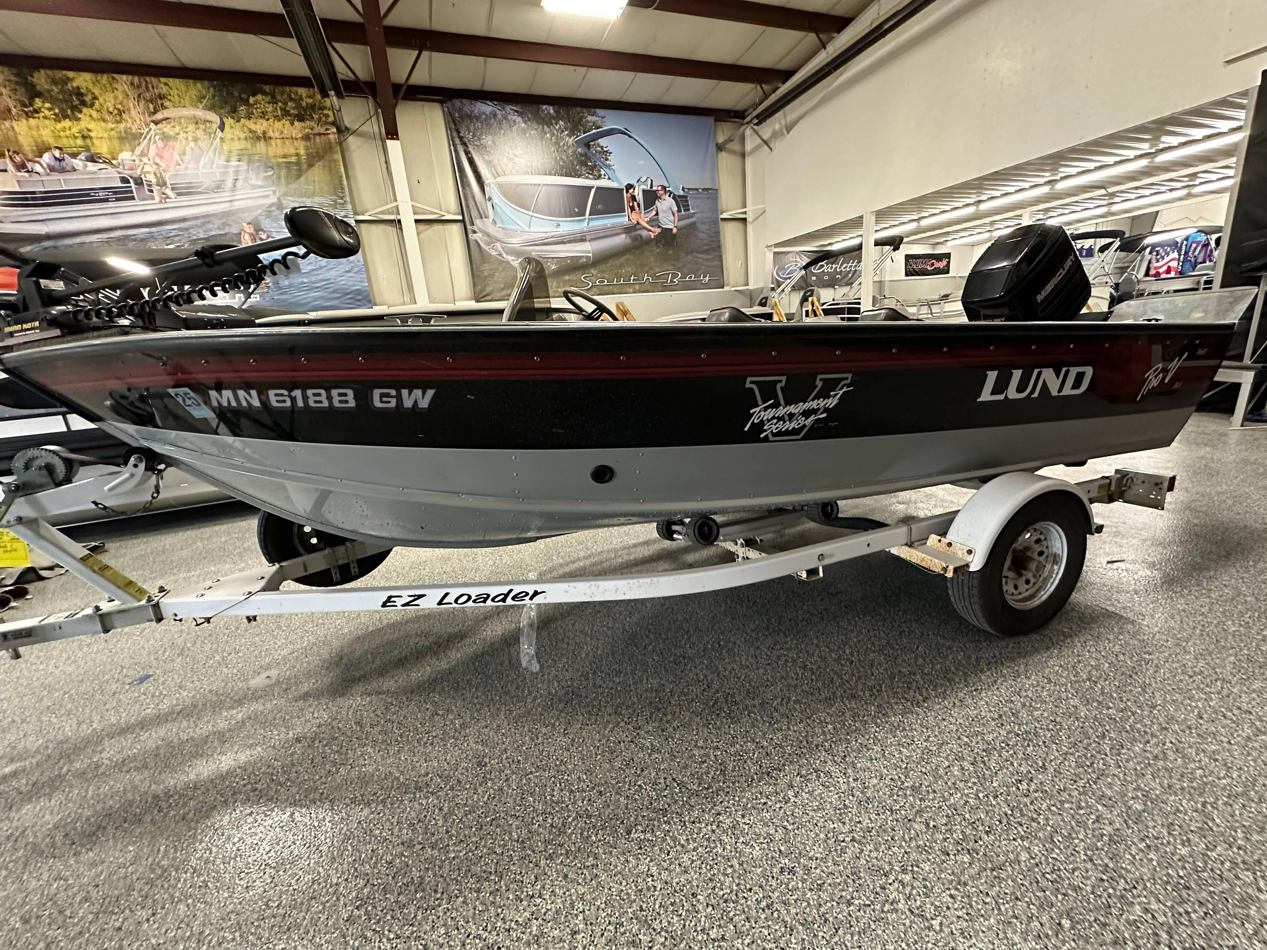 1995 Lund 1650 DLX boat on EZ Loader trailer in showroom.